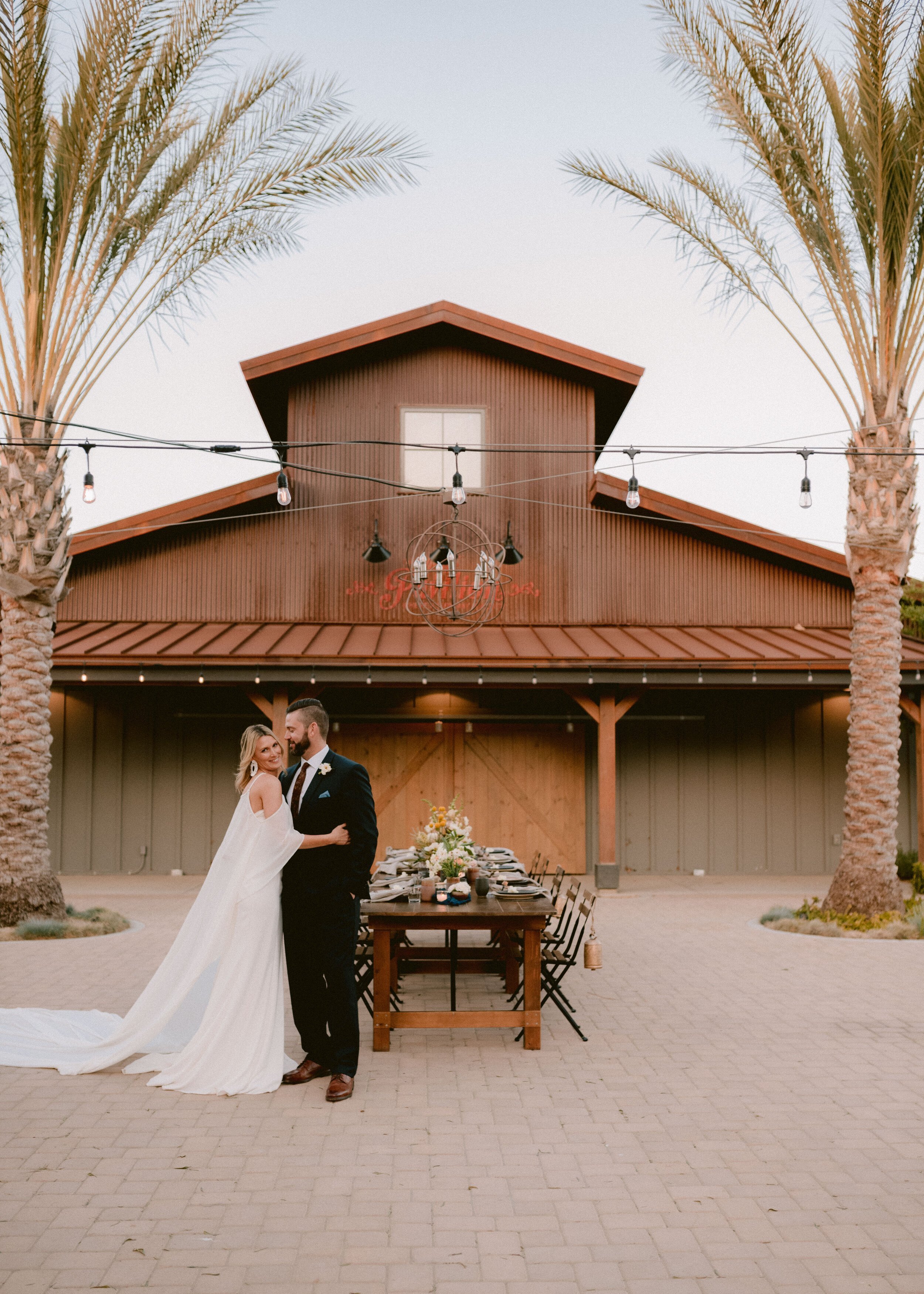 www.santabarbarawedding.com | Flying Flags RV Resort | Mollie Crutcher Photography | Bride and Groom In Front of the Venue's Main Building