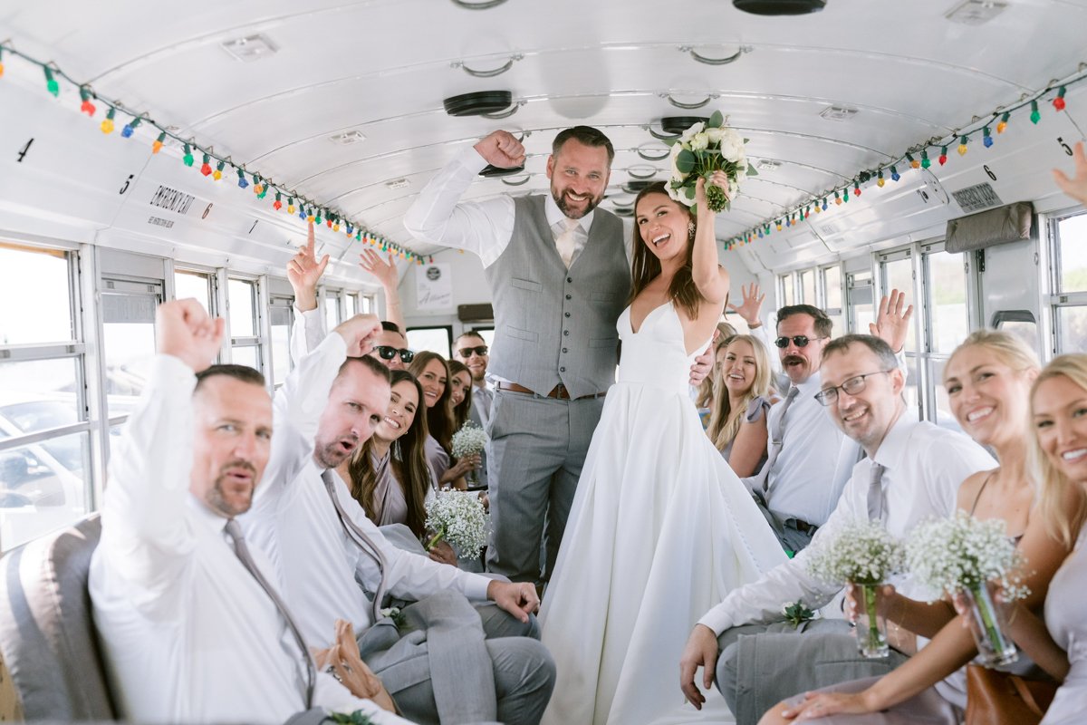 Jump on the schoolbus bride and groom inside.jpg
