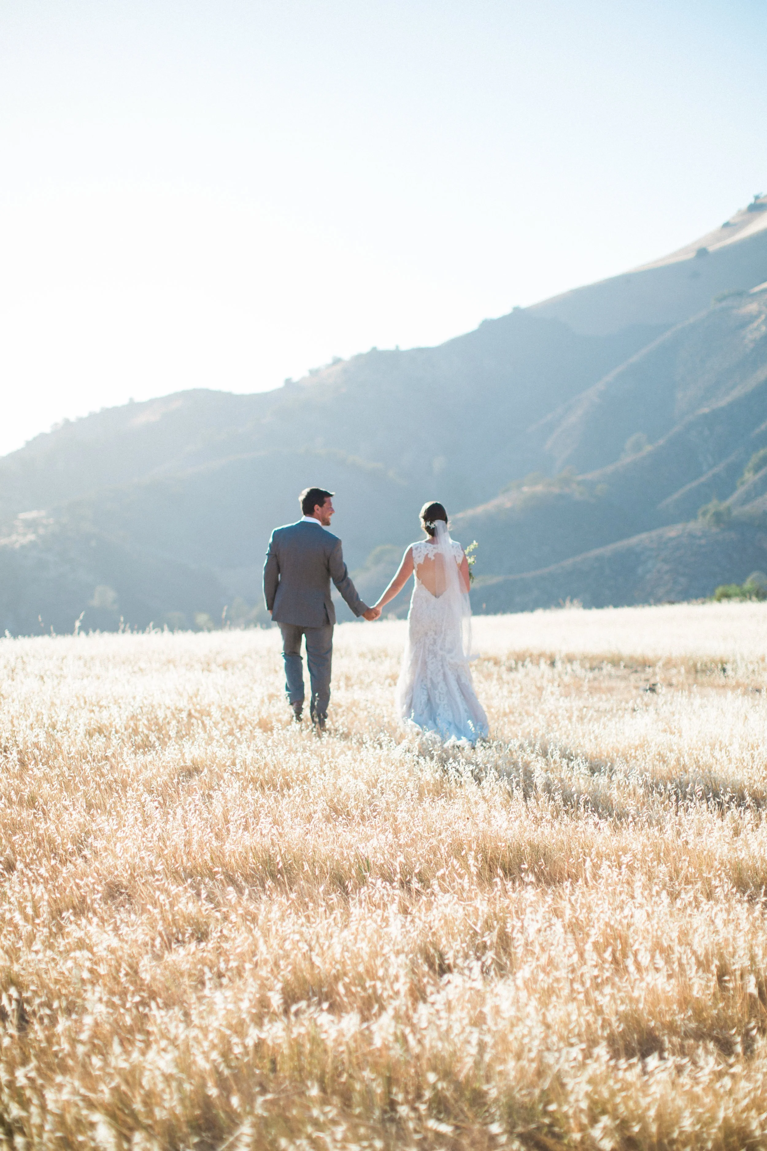 www.santabarbarawedding.com | Kiel Rucker | Couple Holding Hands with the Mountains in the Background