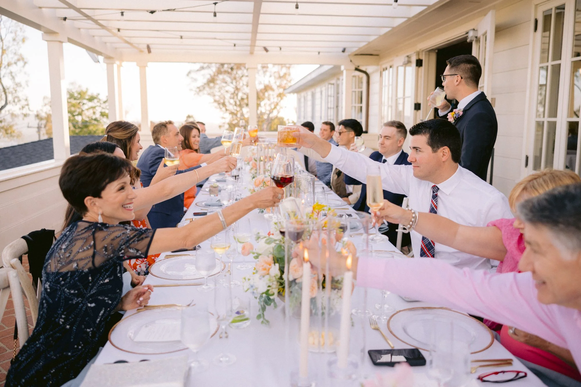 www.santabarbarawedding.com | Kyle London Photography | Belmond El Encanto | Gatherings for Good | Blooms of Santa Barbara | The Tent Merchant | Guest Cheers at Reception Table