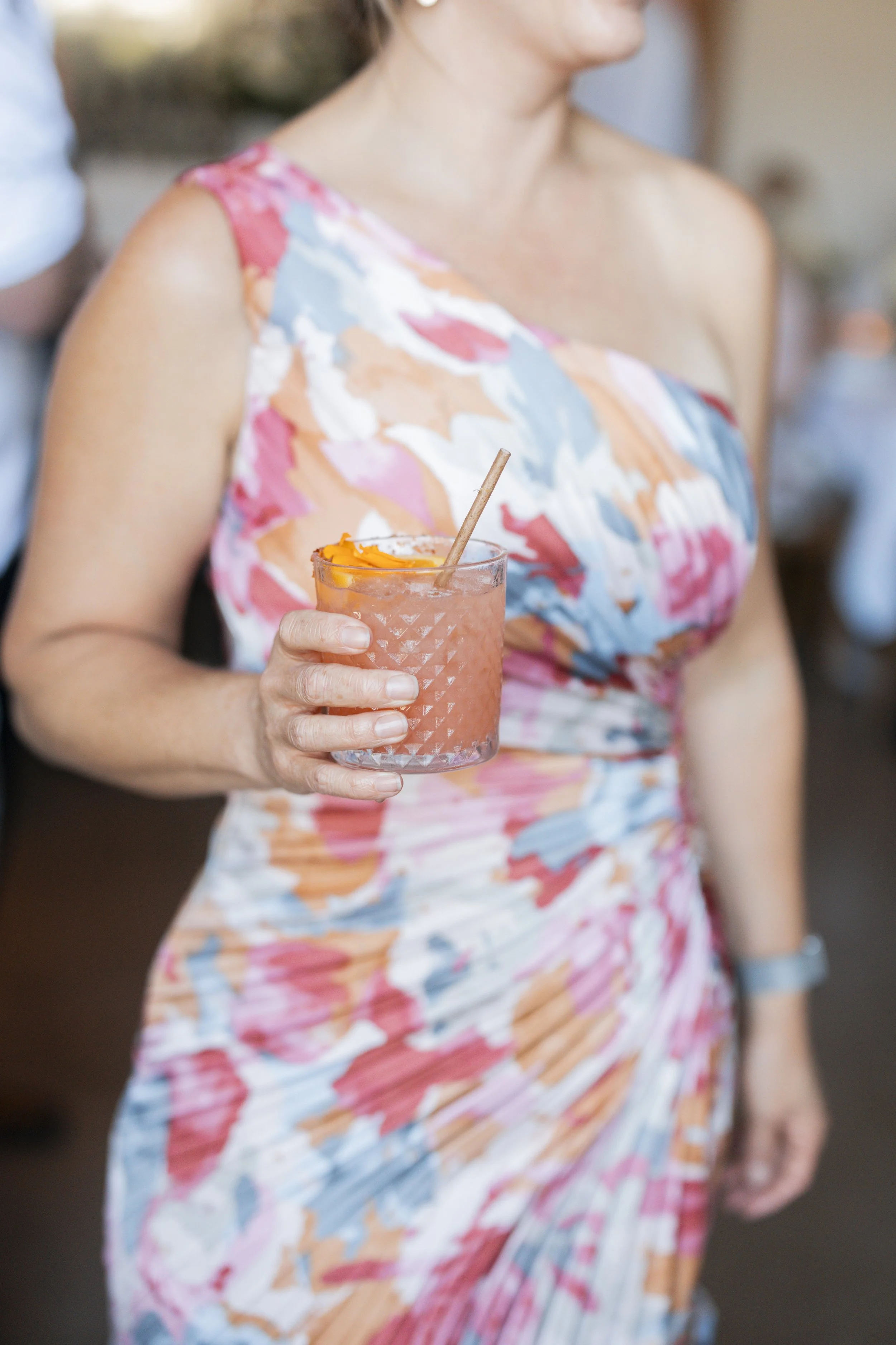 www.santabarbarawedding.com | Lauren Maeve | Gala Restaurant | Coastal Rose Events | The Twisted Twig | Amigo Event Rentals | Guest Holding Cocktail