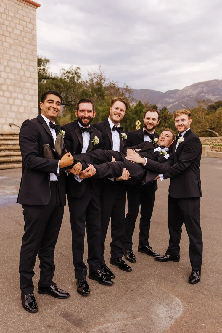 www.santabarbarawedding.com | Allie Dearie Photography | Old Mission Santa Barbara | Groomsmen Holding Up Groom 
