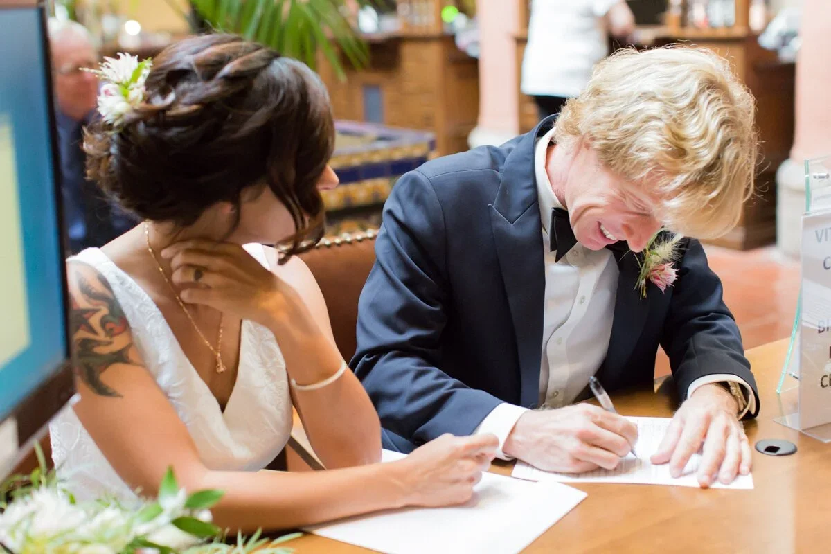 Couple signing papers at elopement