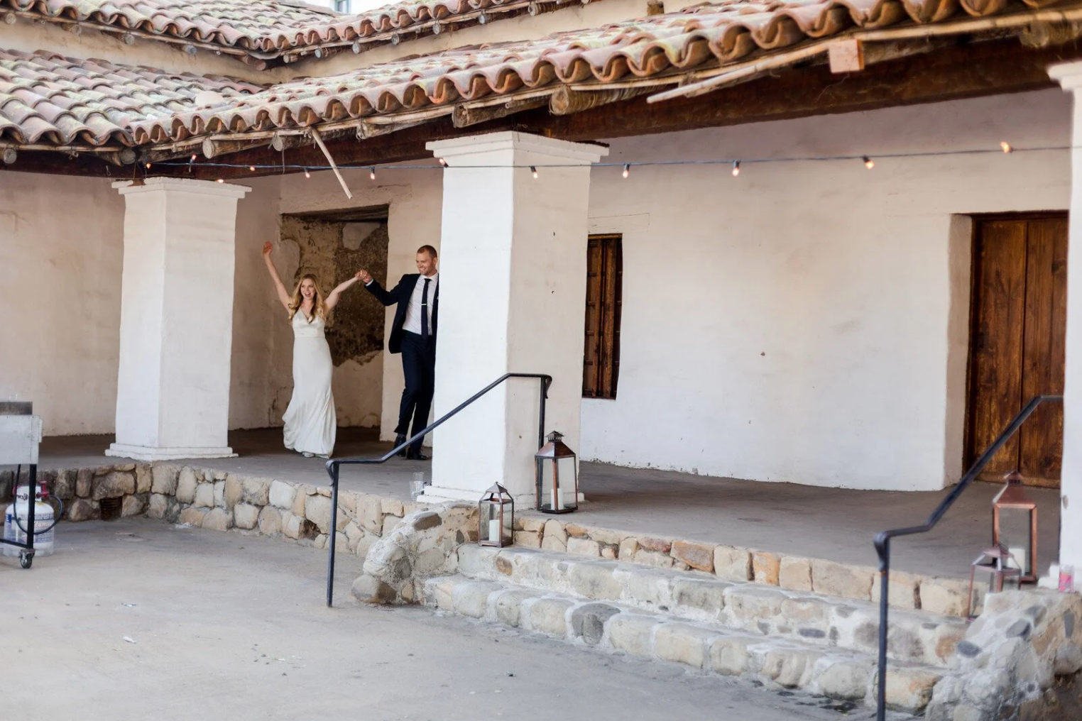 Bride and groom entering reception at Casa de la Guerra