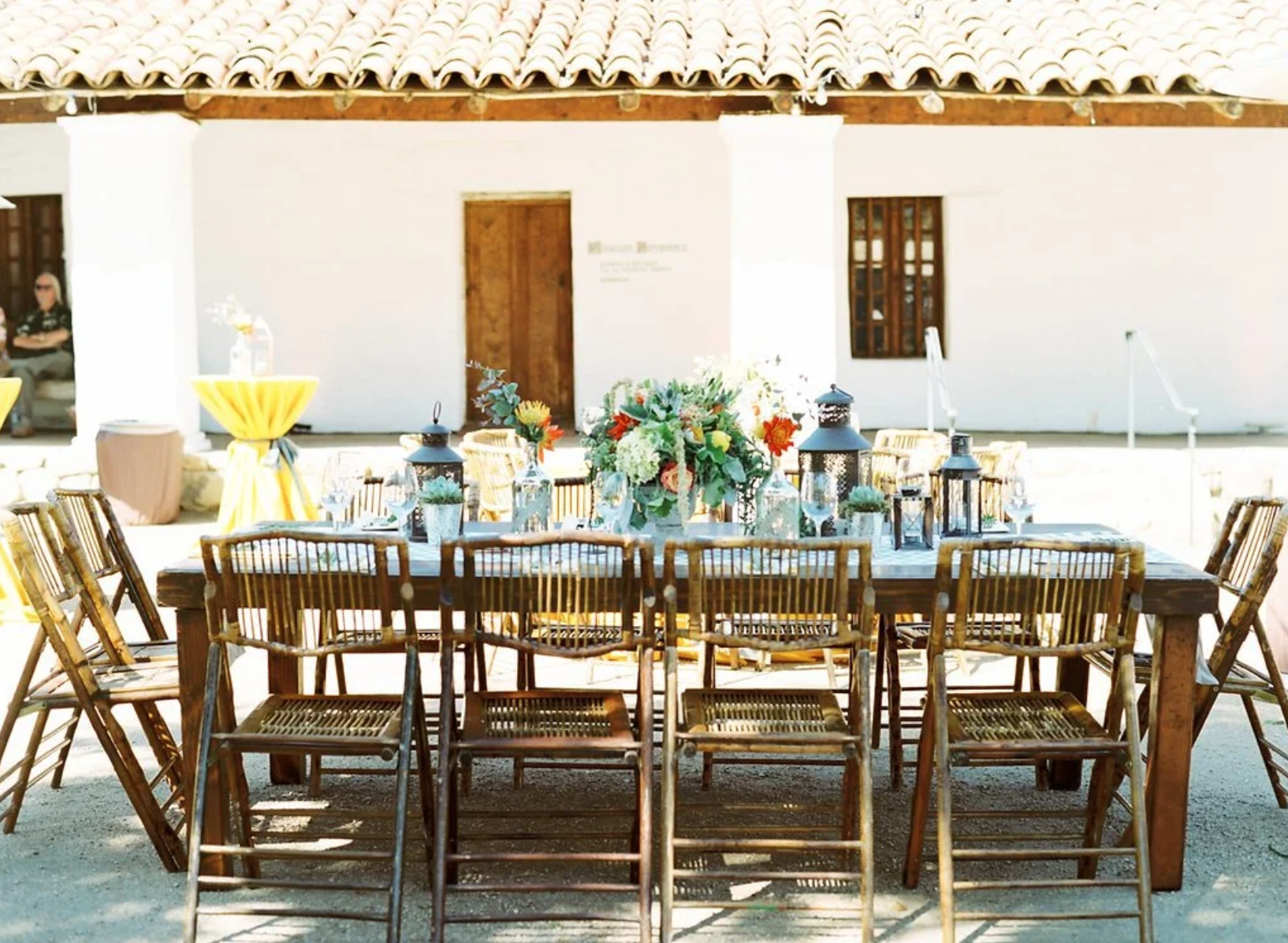 Reception table with colorful flowers and lanterns