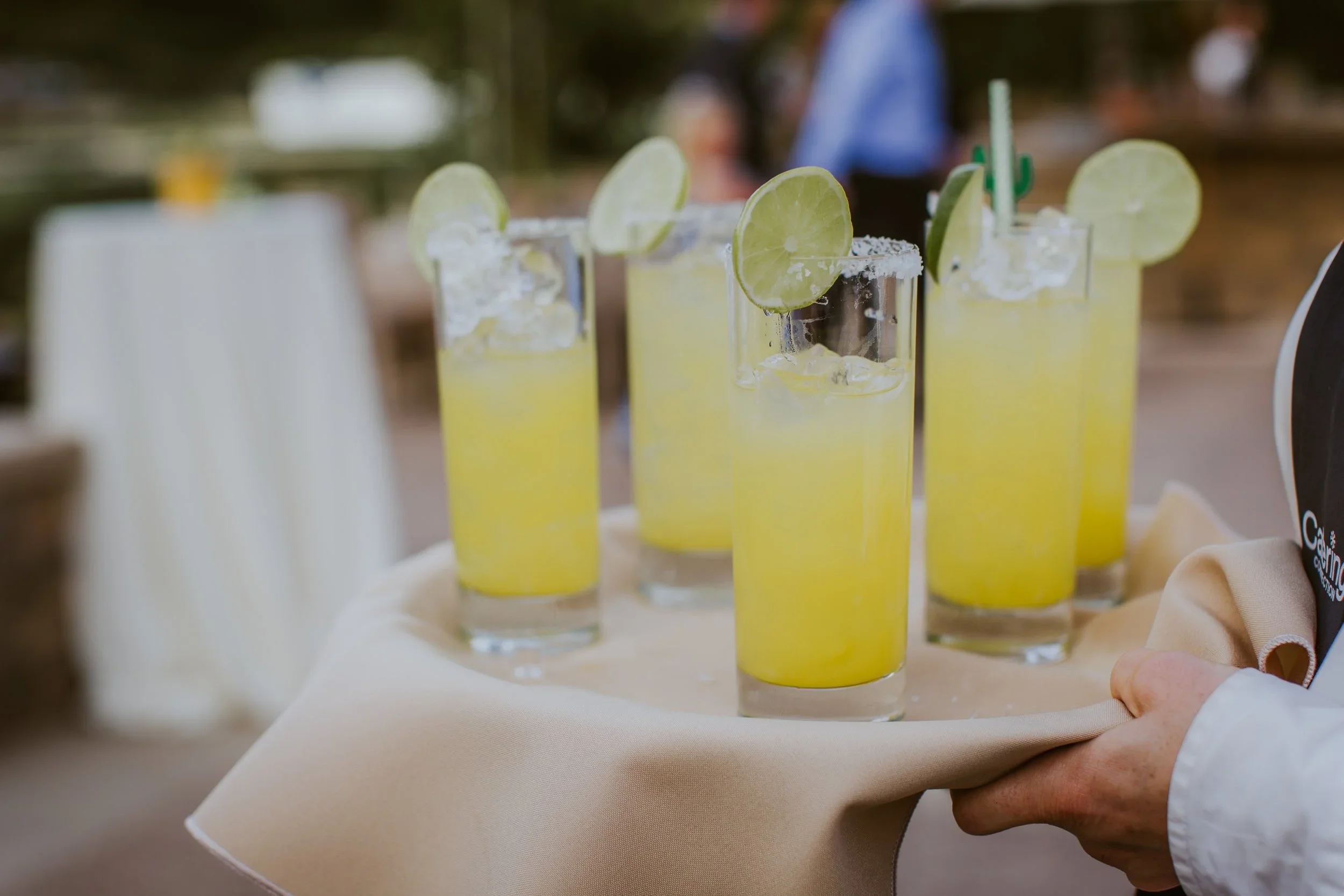 Waiter serving margaritas at reception