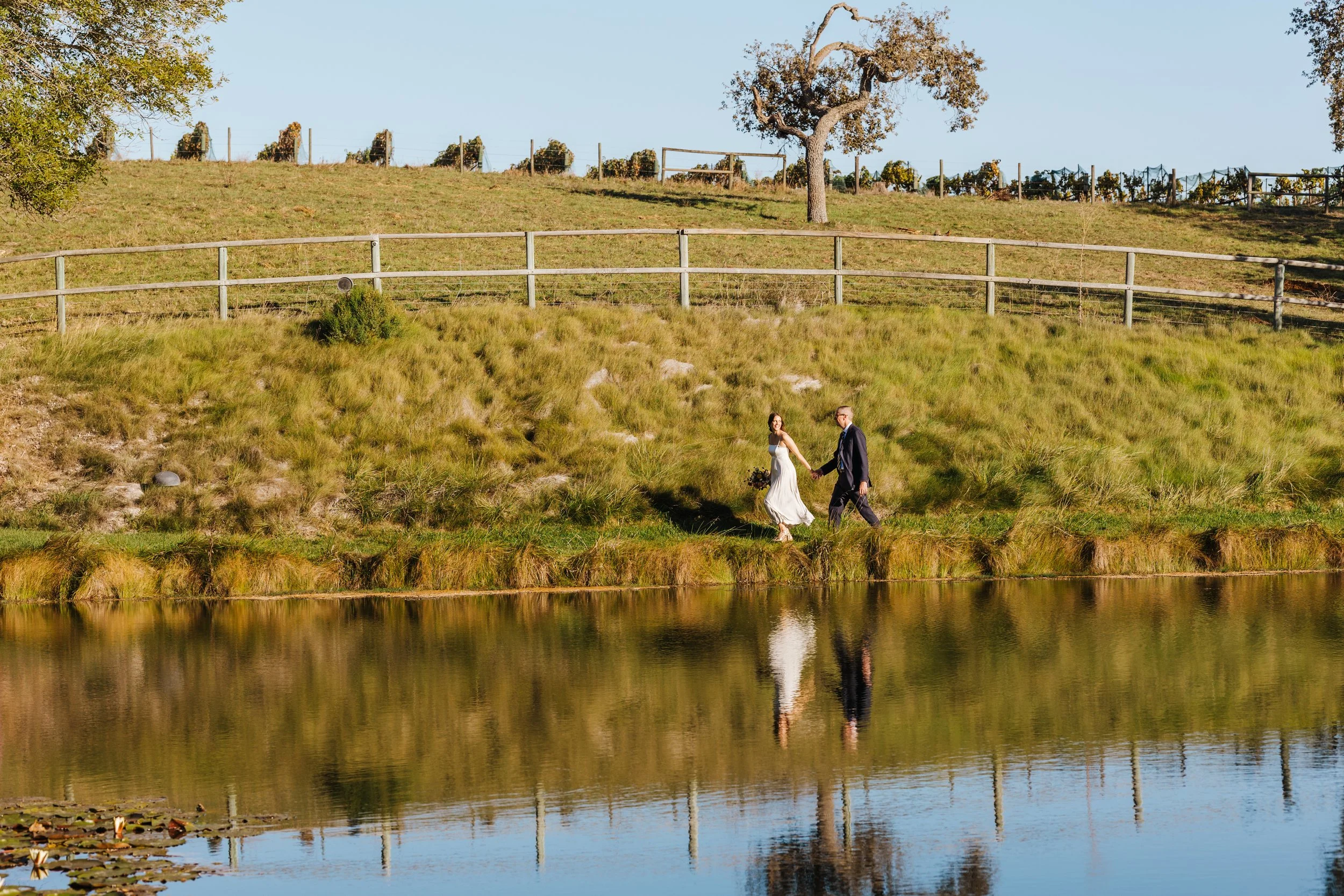 Couple walking by the pond at elopement