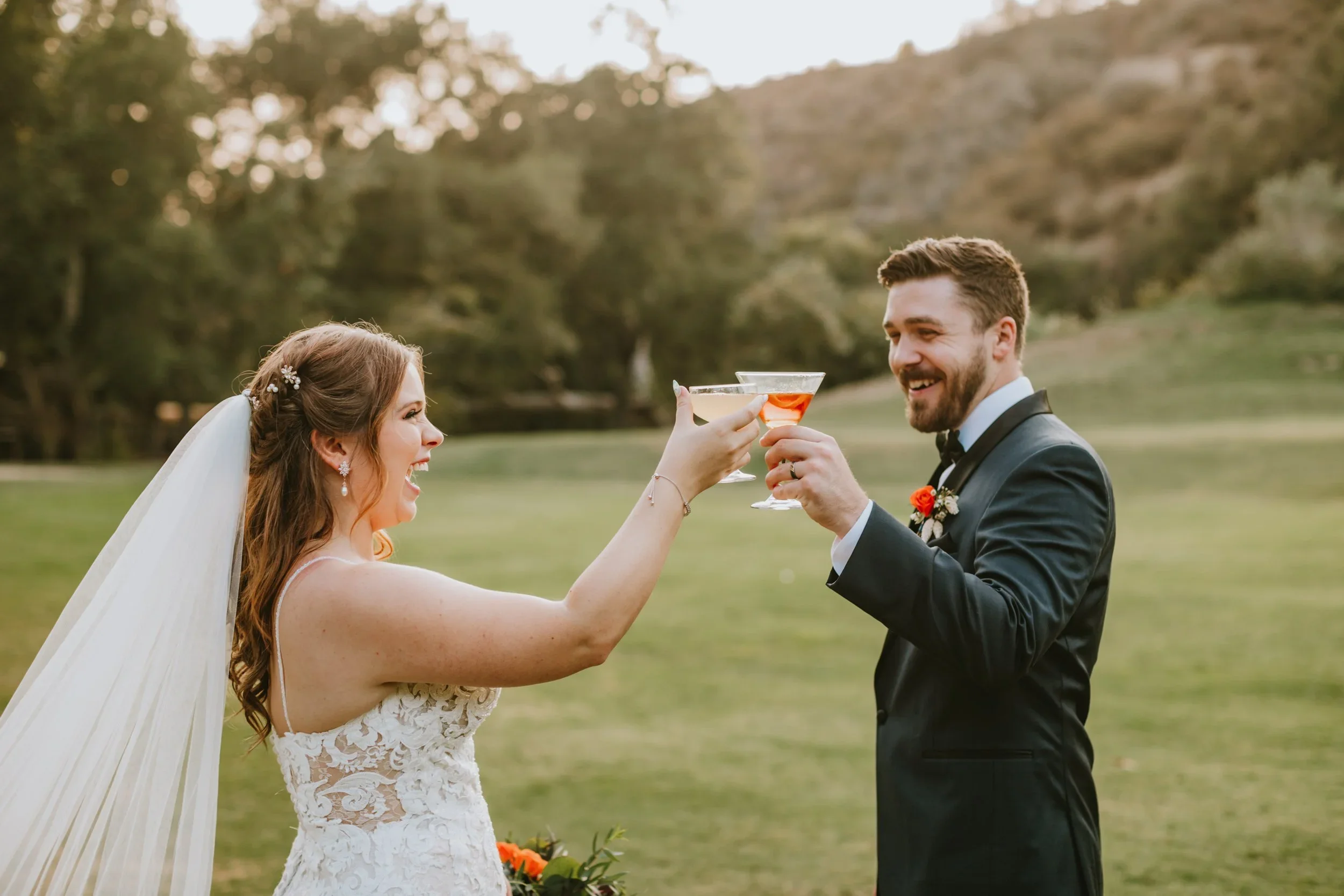 Bride and groom clinking glasses at Santa Barbara wedding