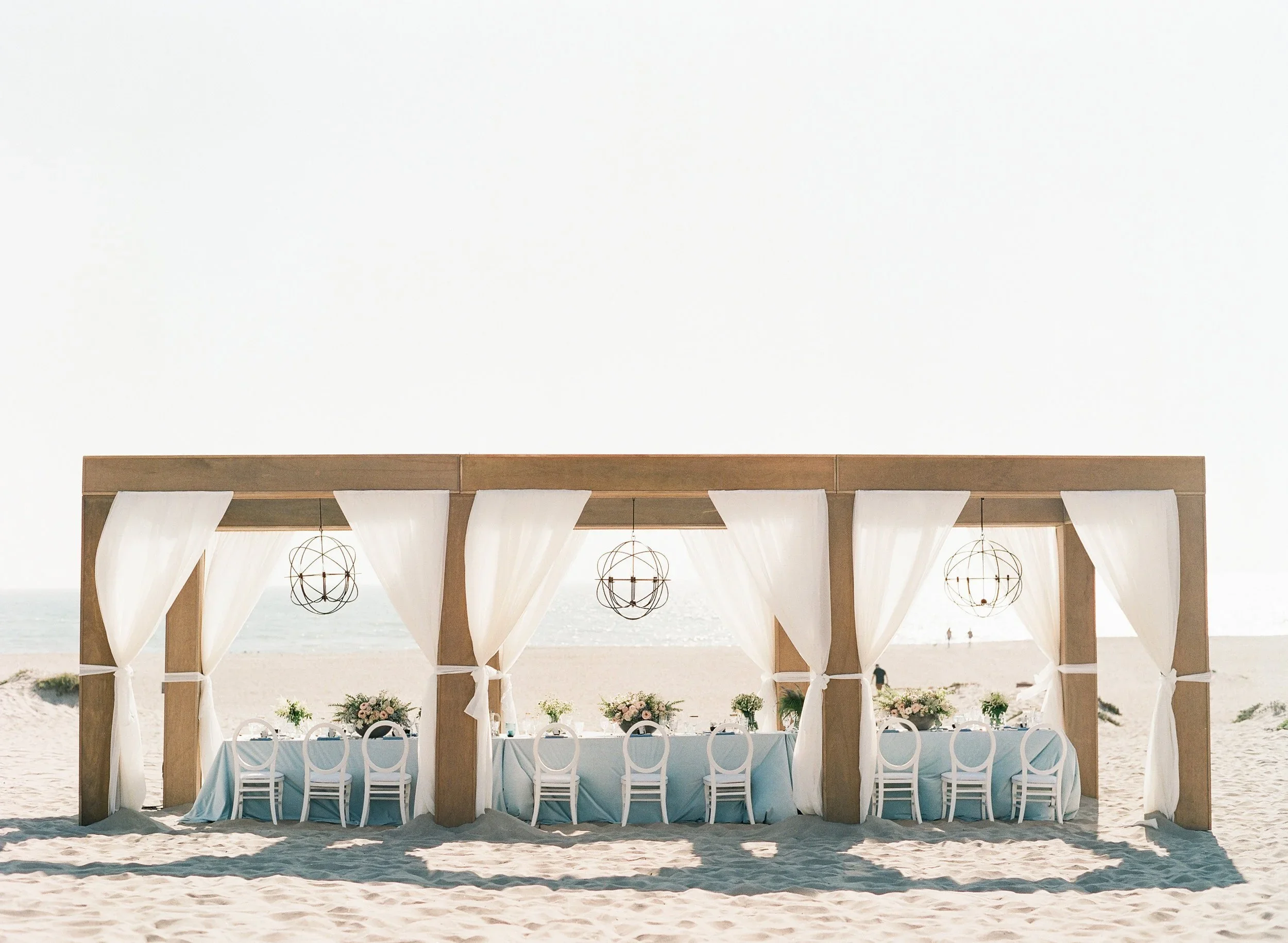 Santa Barbara wedding reception set up on the beach.