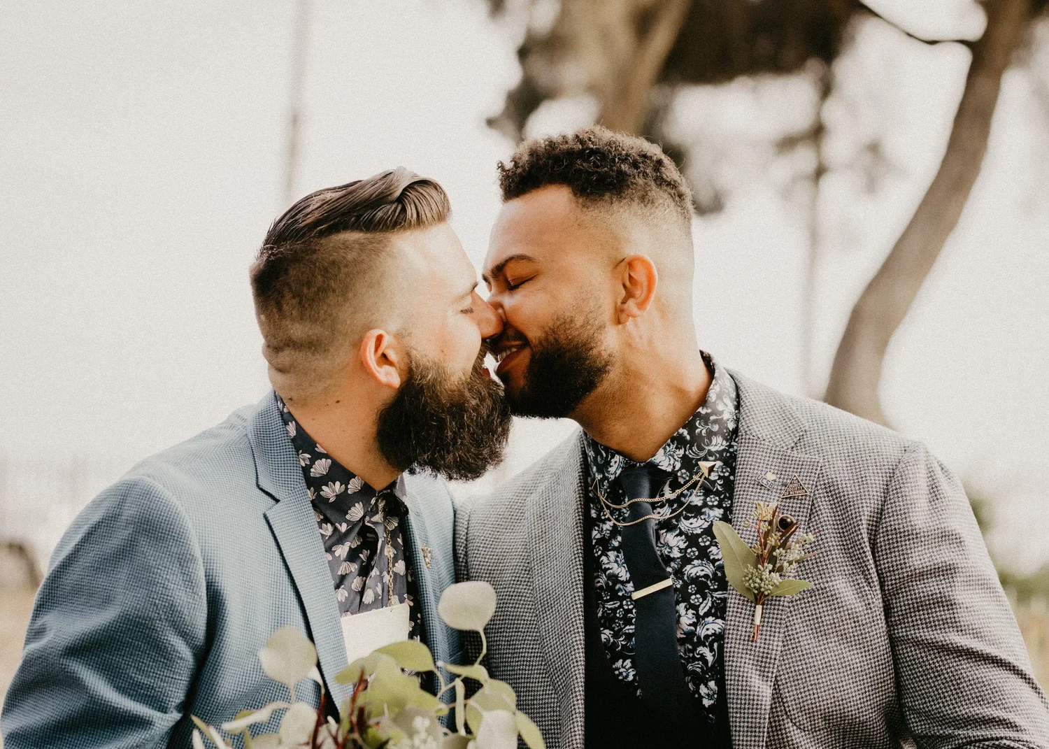 Grooms kissing at their wedding day