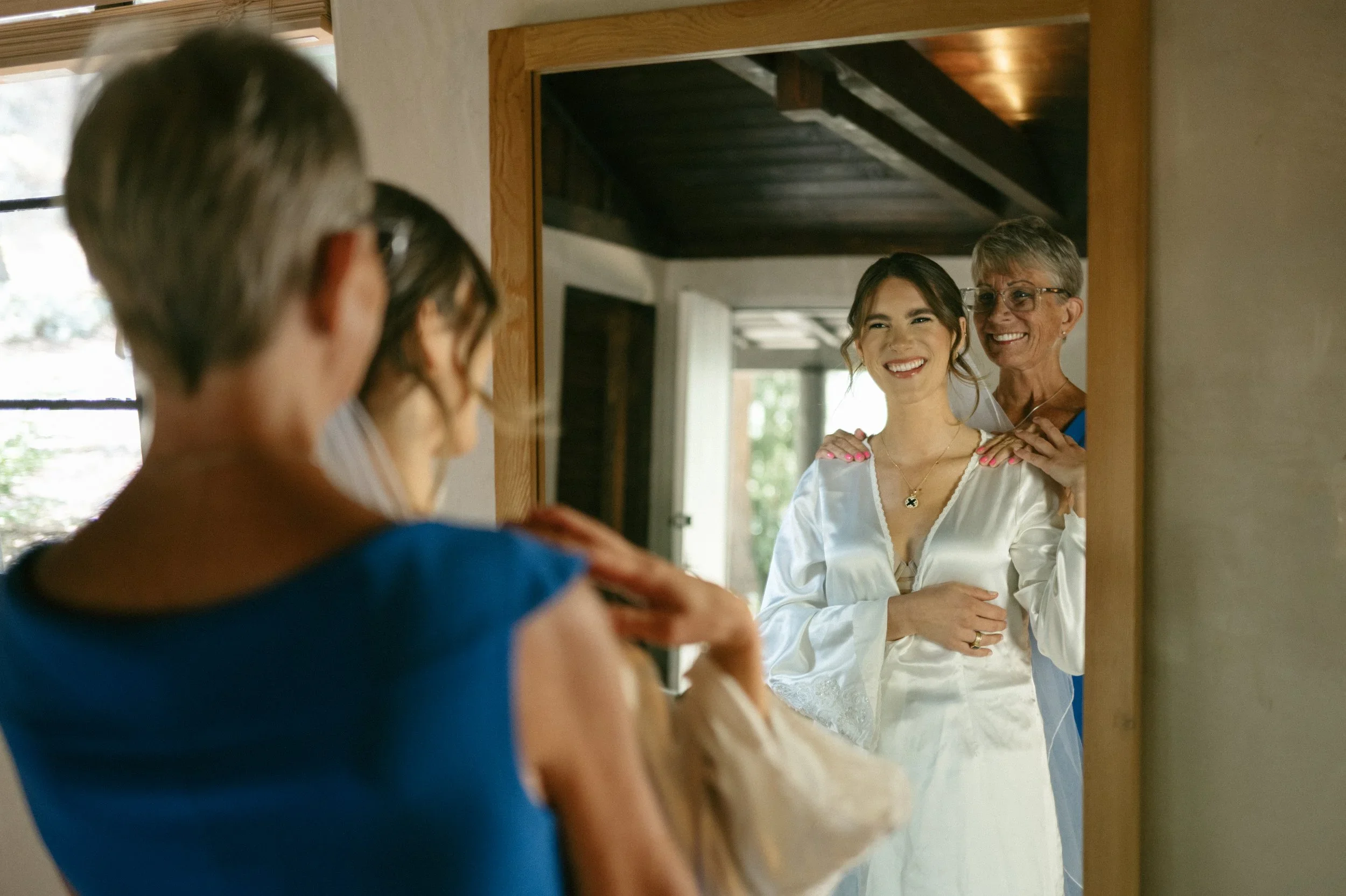 Mom helping the bride get ready in mornin