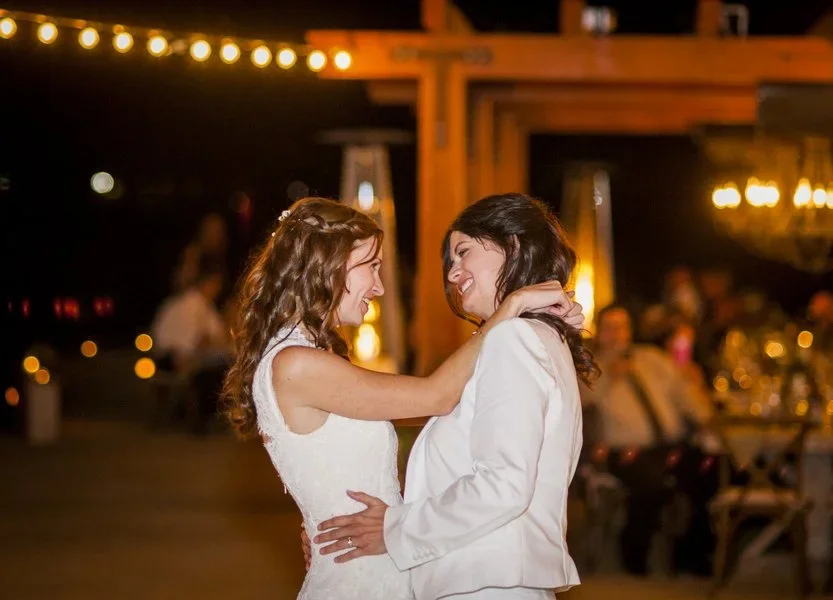 LGBTQ couple dancing at wedding reception