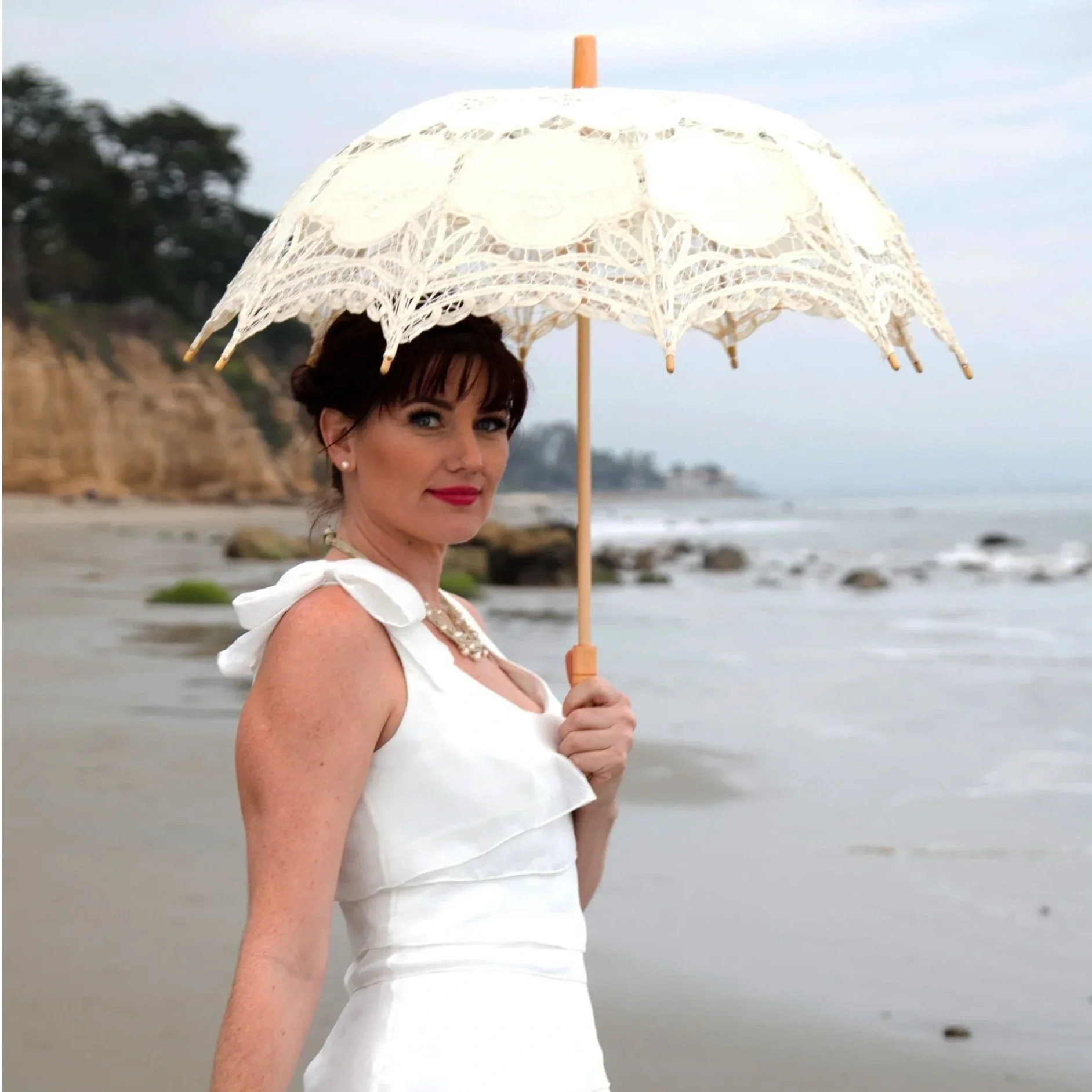 Bride with white lace parasol