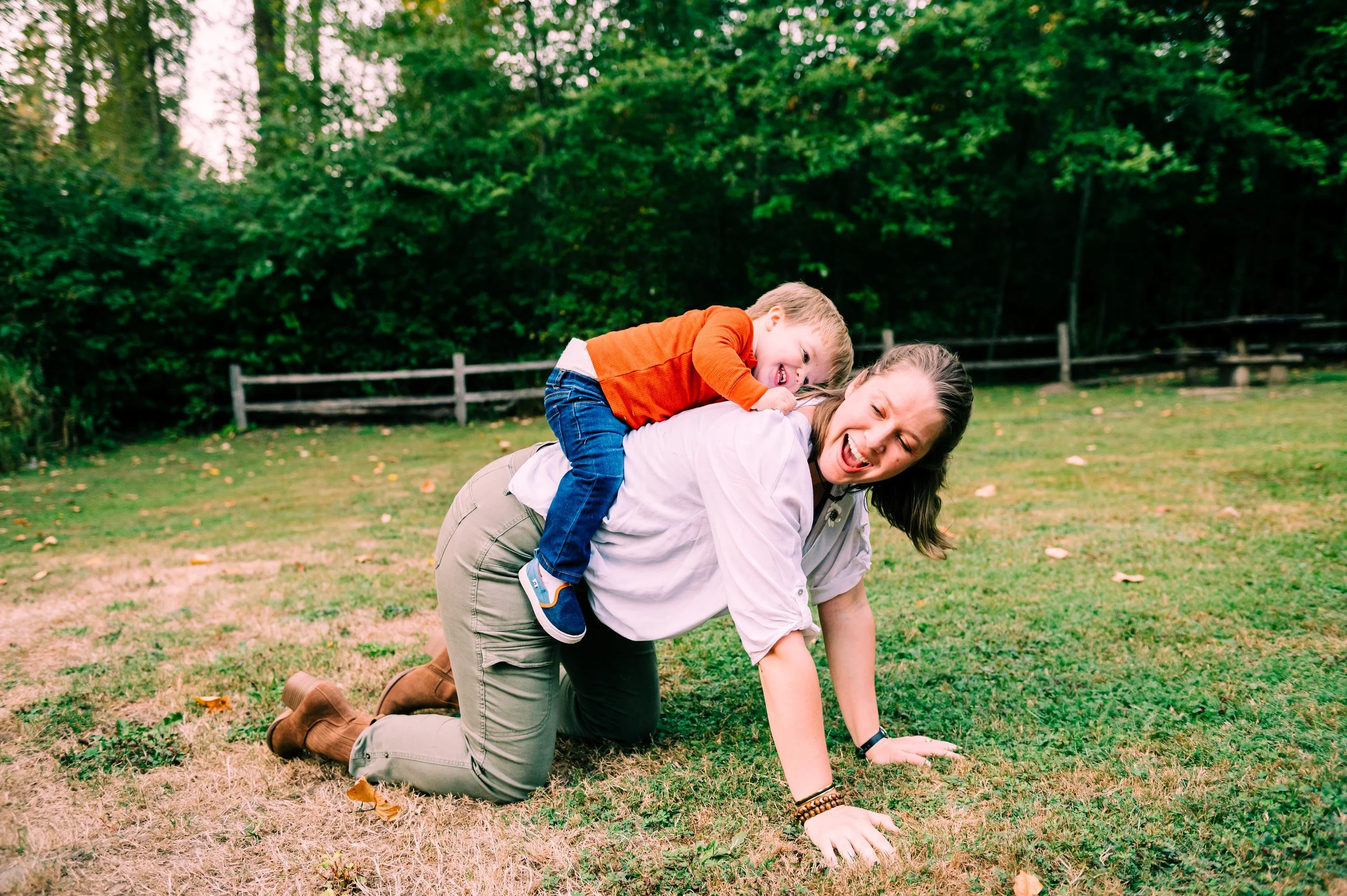 Mom doing horsey back ride with son at a family portrait session in Kenmore