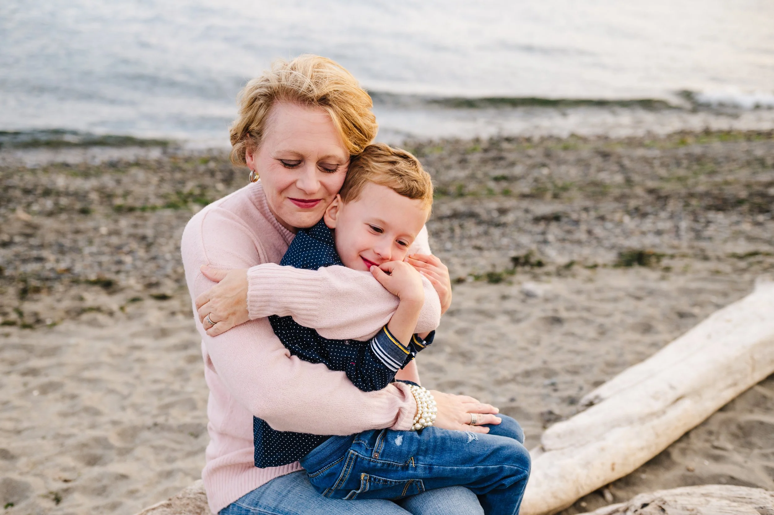 Seattle mom hugging son at a family photo session at the beach