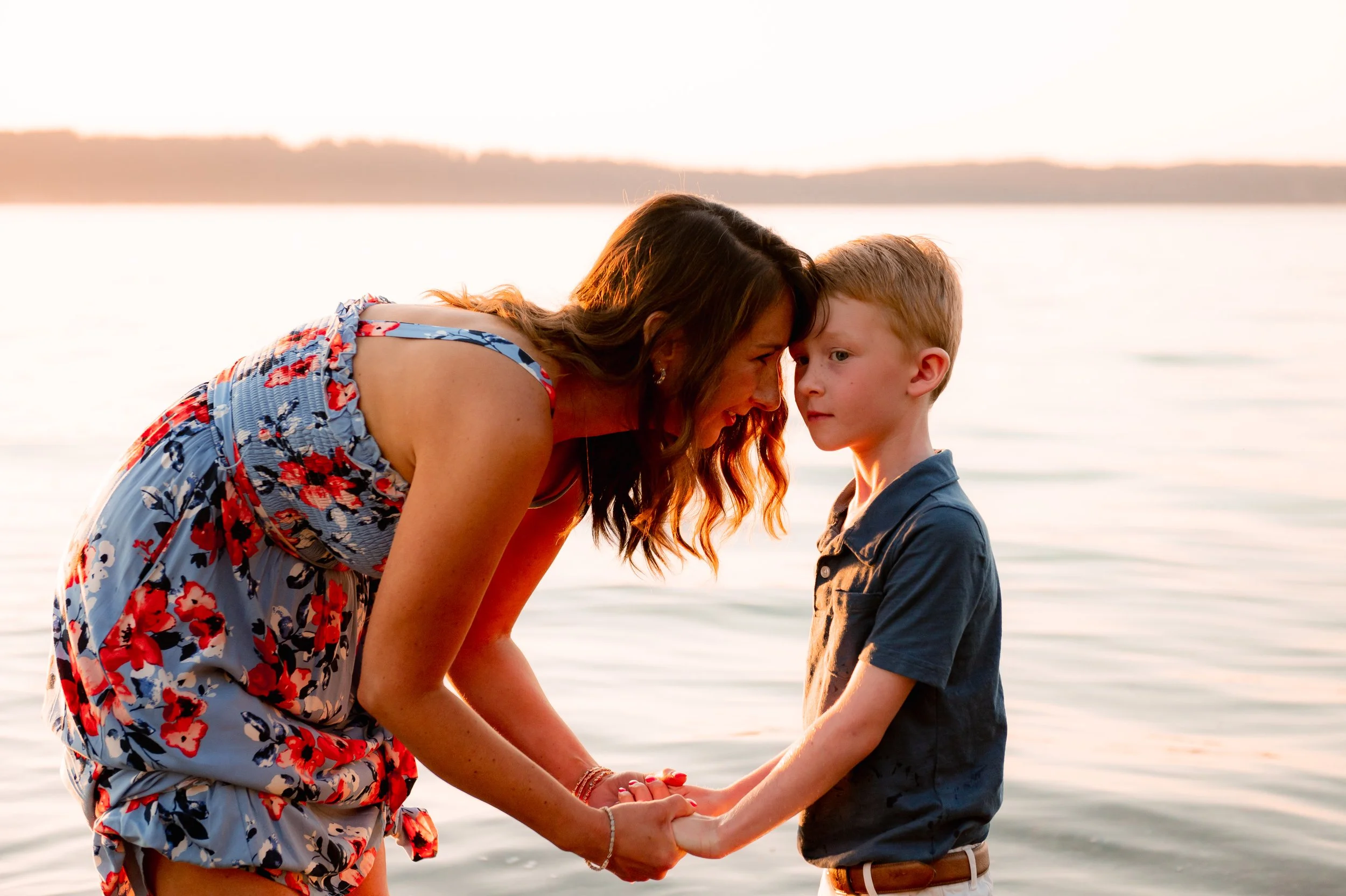 Sunset family photo shoot near Bothell with mom and son in water