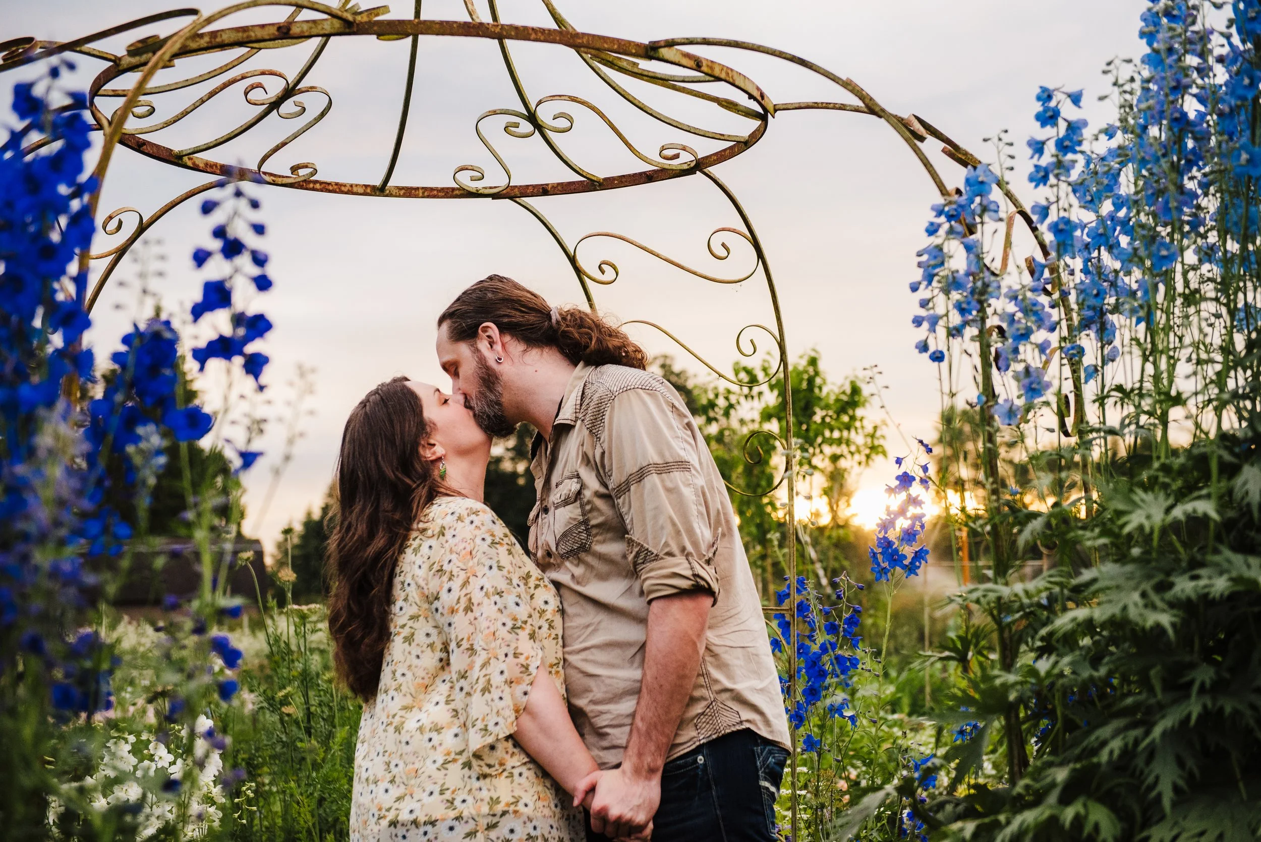 Sunset engagement photoshoot with flowers surrounding the couple in Snohomish