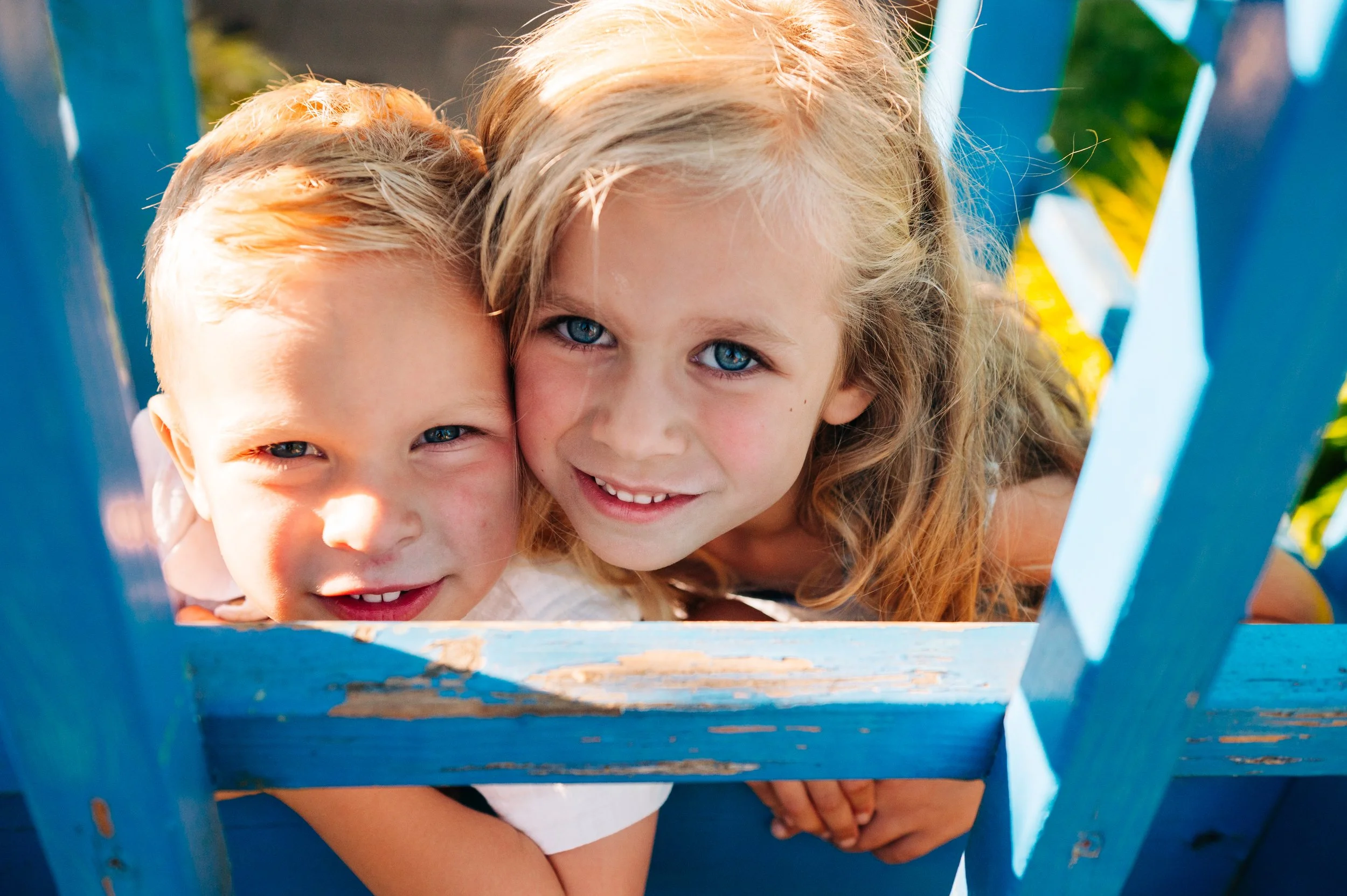 Siblings playing peek-a-boo during a family photo shoot for a Snohomish family of five
