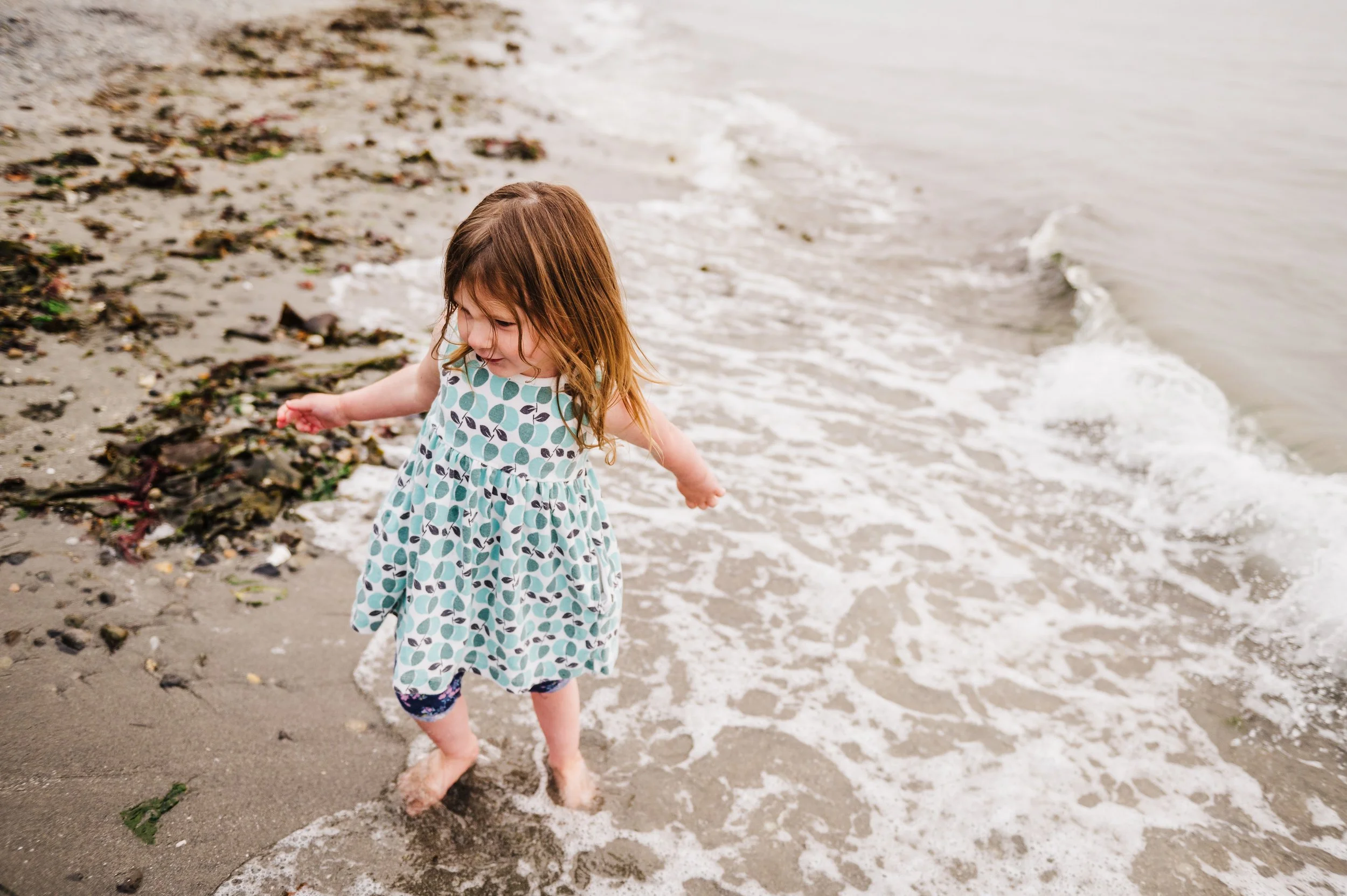 Golden Gardens Family photos with red headed toddler in the waves