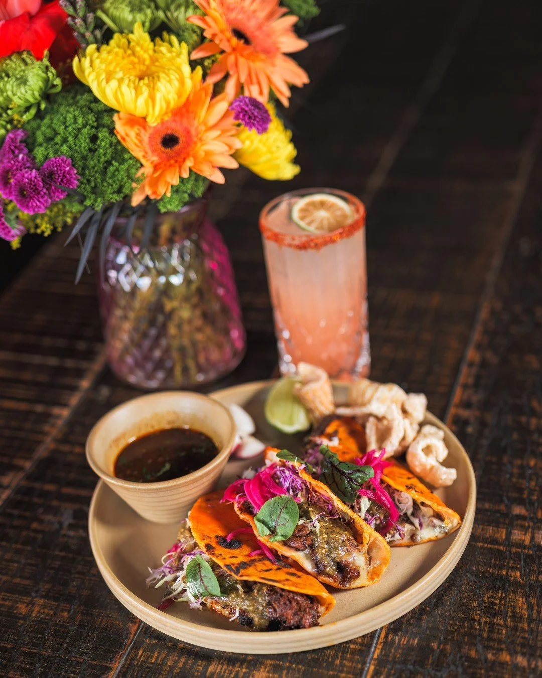 Have you tried our new Birria Tacos at La Mona Rosa?

Slow-braised prime chicken, melted Mexican cheese, roasted green salsa, and crispy pork chicharrones&mdash;tucked into golden-fried tortillas and served with rich consomm&eacute; for the perfect d