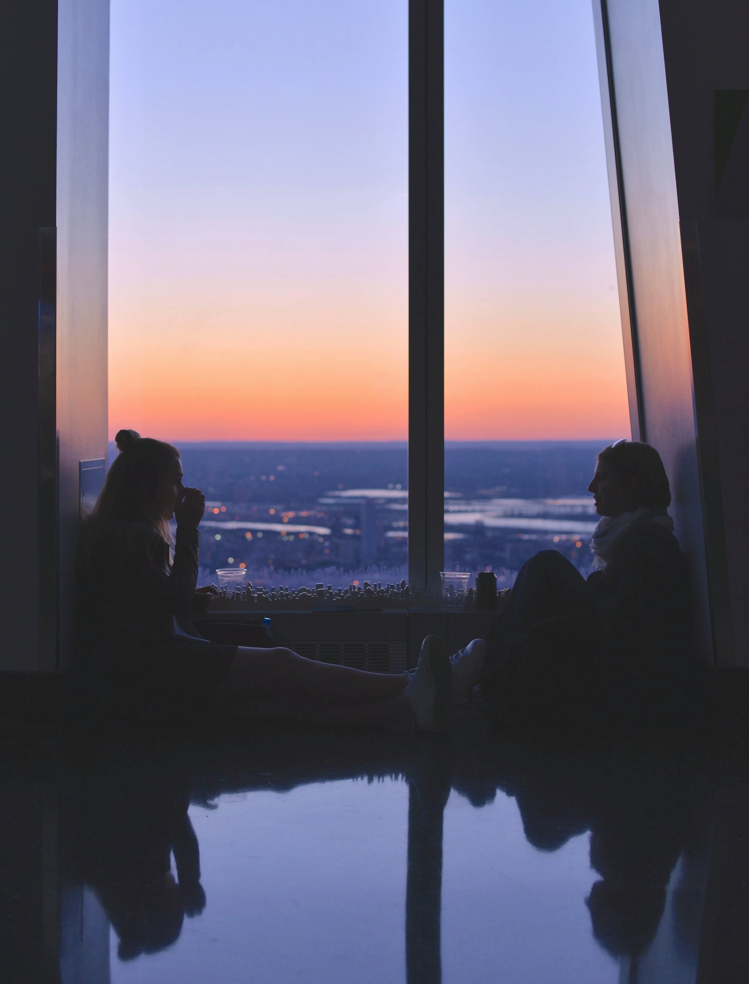 One World Observatory New York vase windows, two girls sitting