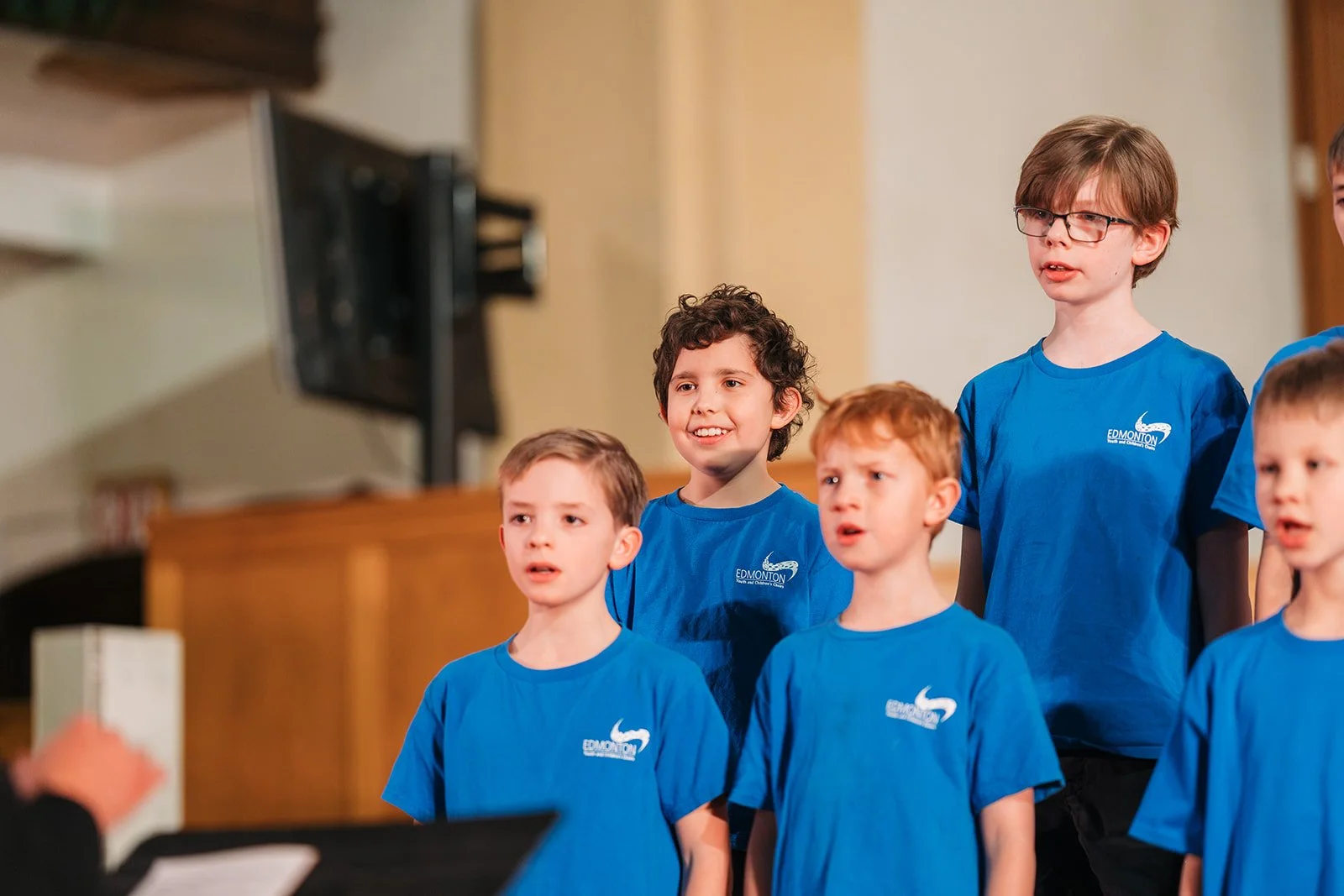 Spiritus boys choir performing in blue t shirts at a christmas concert