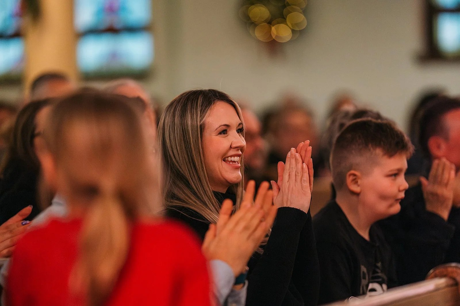 photo of a parent clapping at an edmonton youth and children's choirs concert