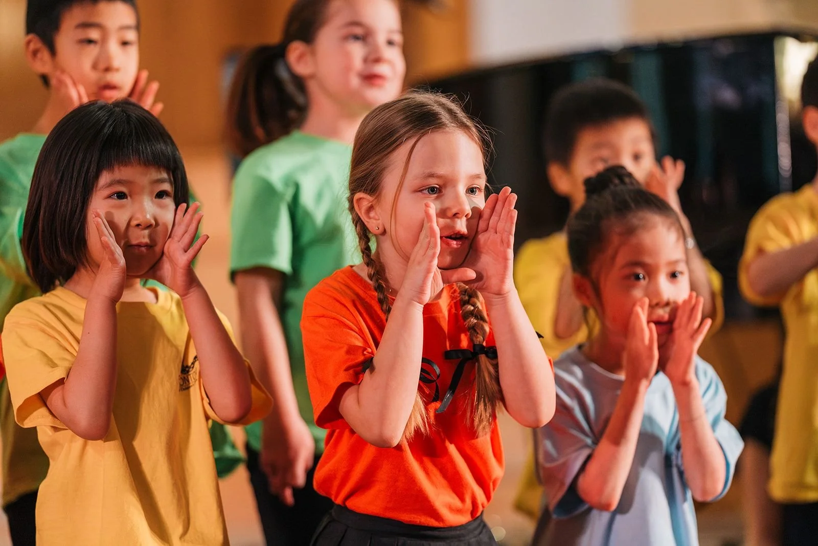kindergarten and grade one singers from edmonton youth and children's choirs singing on stage