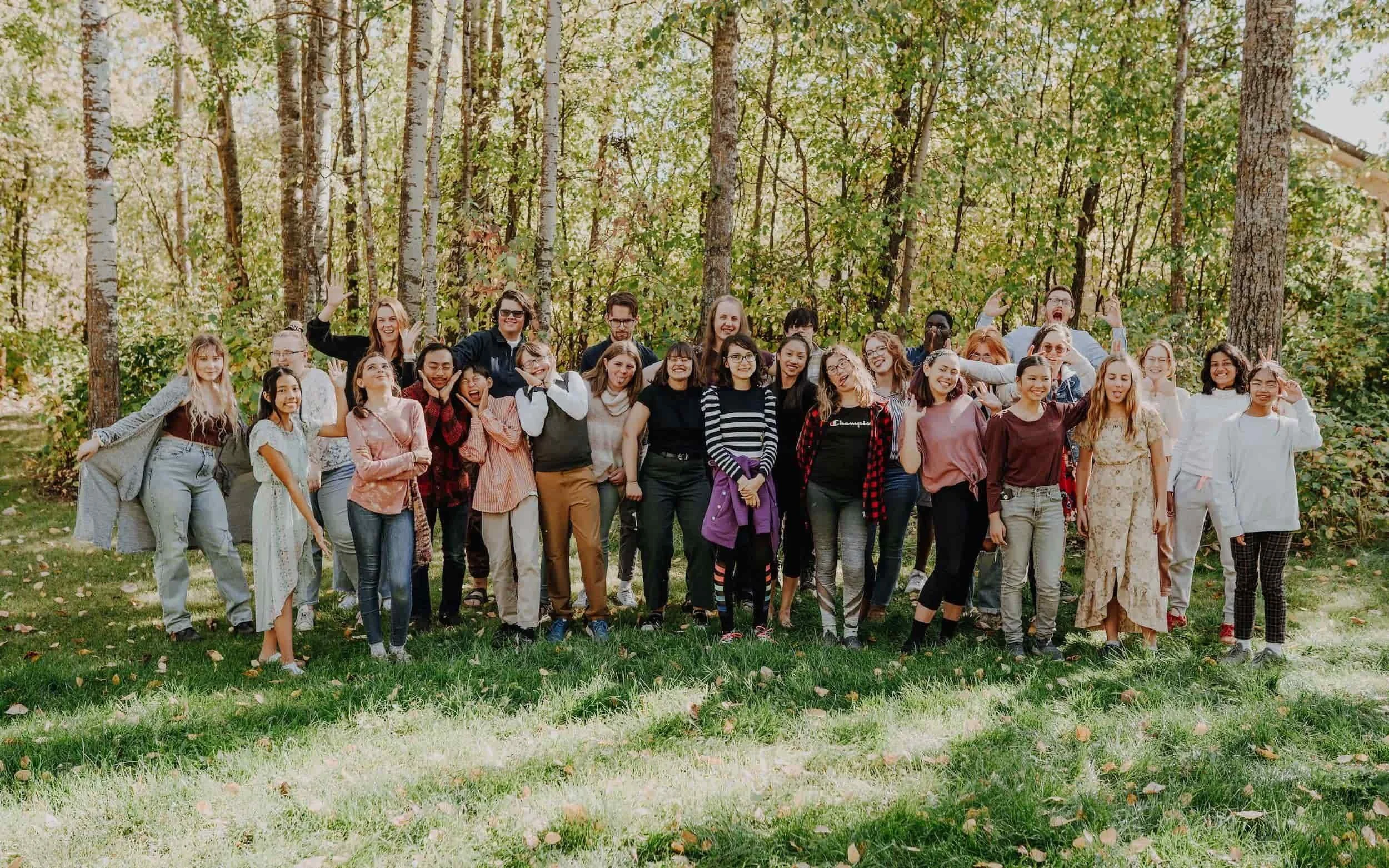 photo of the edmonton youth and children's choirs at camp nakamun standing in the trees