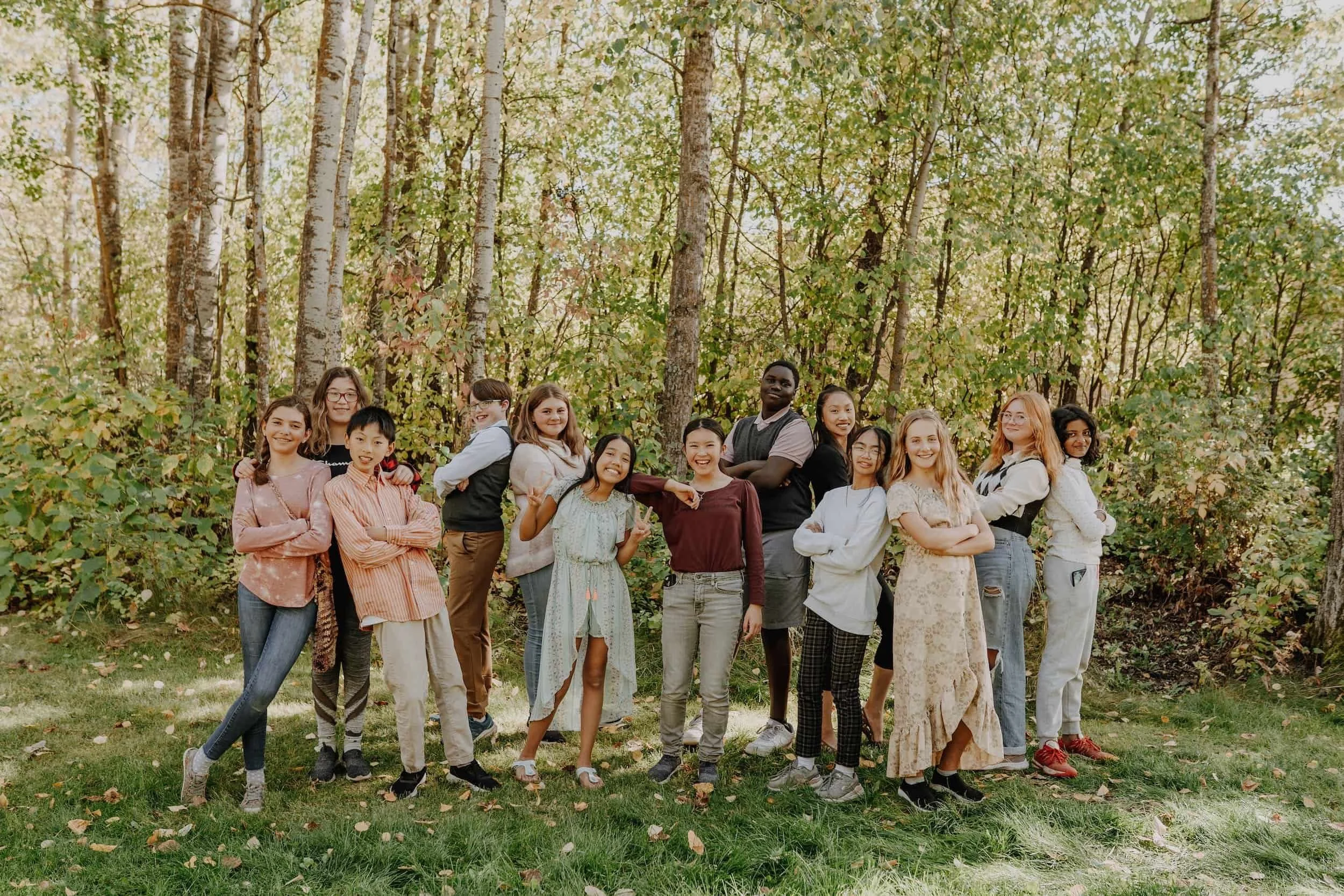 Group photo of Edmonton Children's Choir at Camp Nakamun in the trees