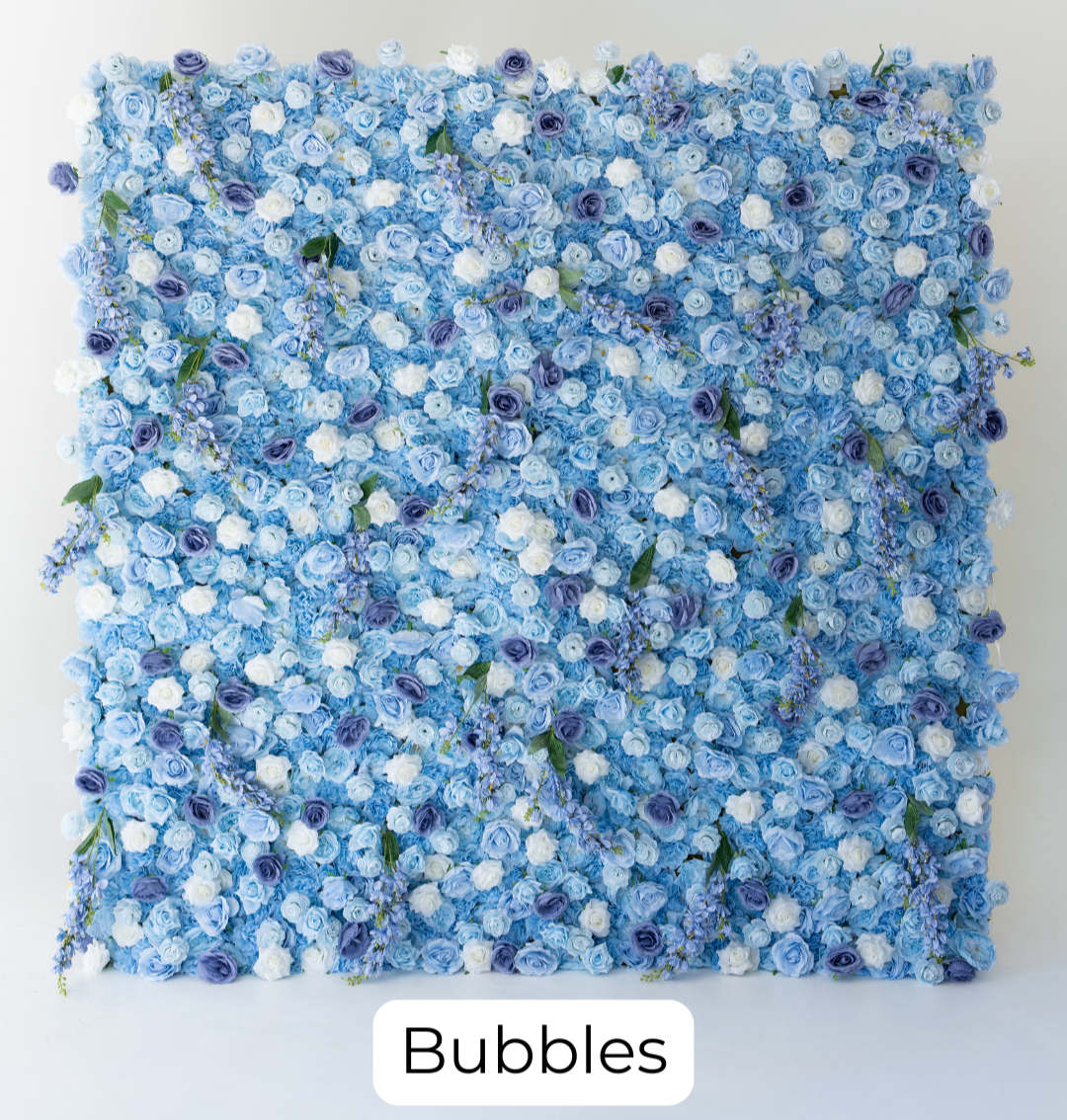 Bubbles features a soft blend of blue tones layered with lush roses, creating a vibrant yet elegant look. White floral accents add brightness and contrast, making it a perfect choice for baby showers, birthdays, and modern celebrations.
