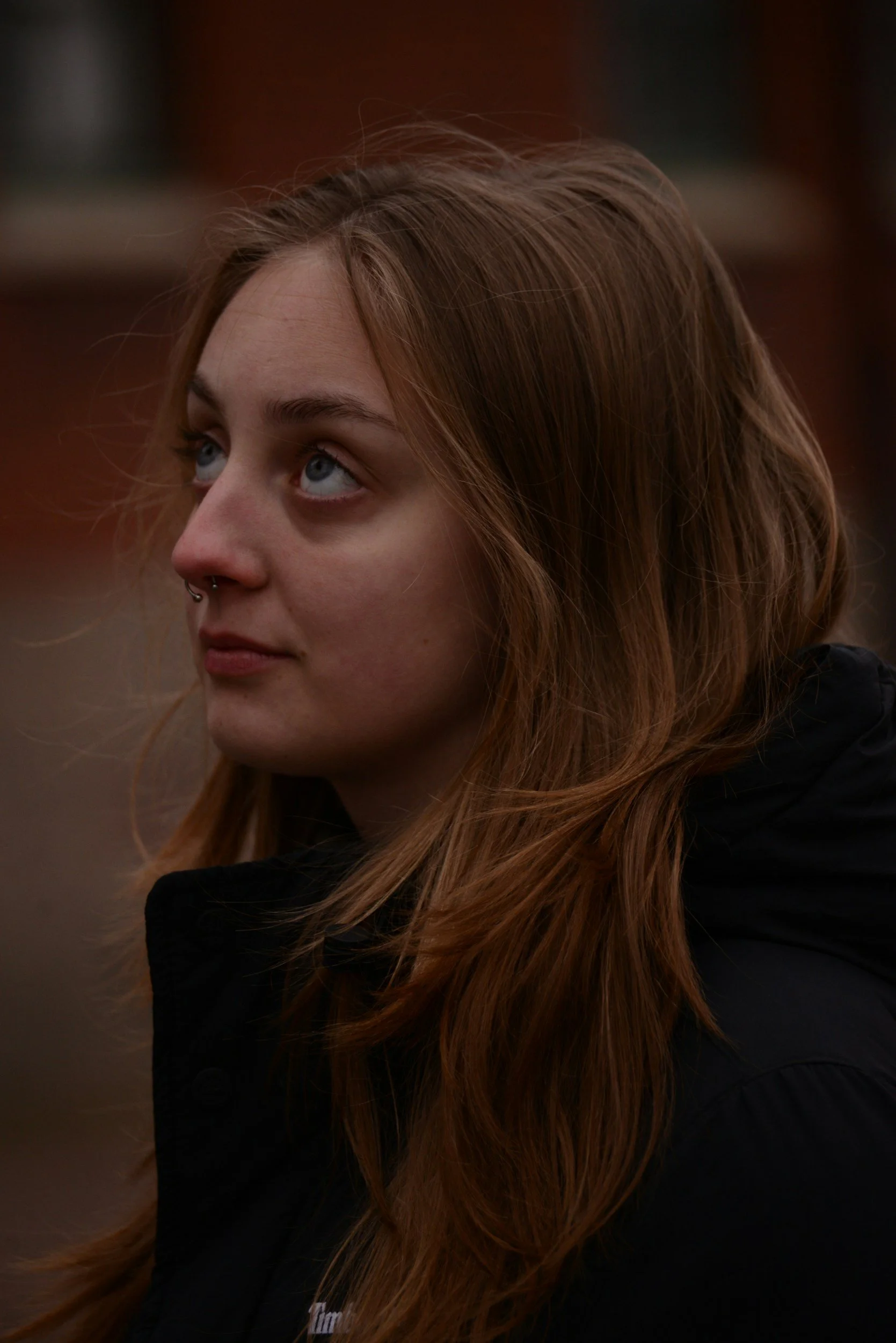 A young adult reflecting on life transitions, symbolizing the journey toward mental wellness.