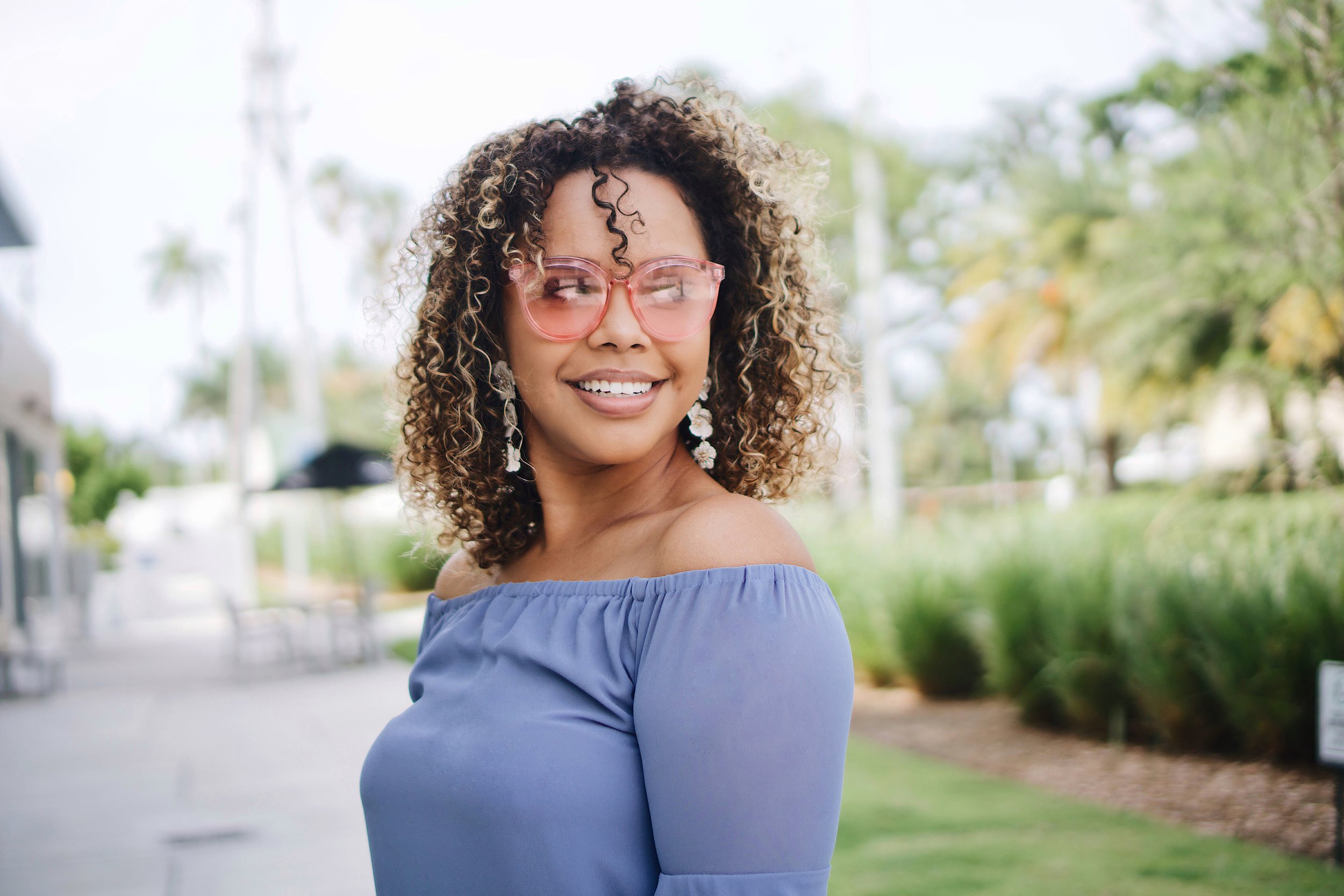 A smiling, confident woman representing the mental wellness and counseling services for women at Everthrive Counseling in New Port Richey.