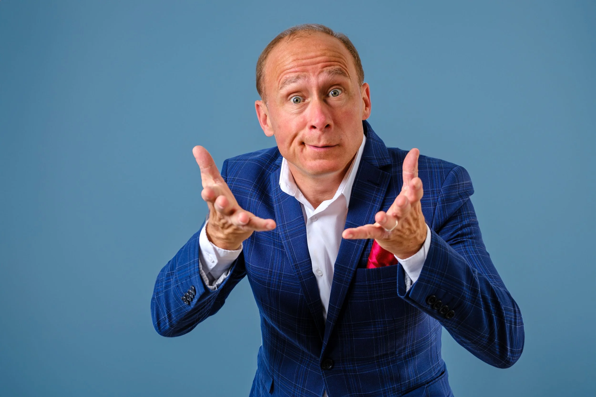 Character portrait of Norfolk comedian Ben Langley in a blue suit, photographed by Daniel Mason Photography.