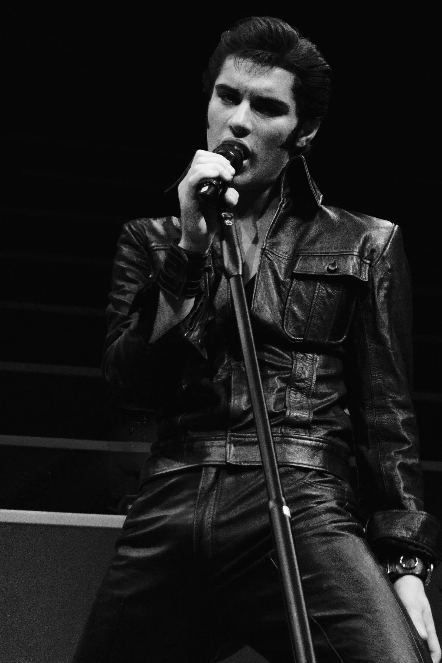Emilio Santoro as Elvis Presley in black leather at The Halls Norwich, evoking the iconic 1968 Comeback Special.