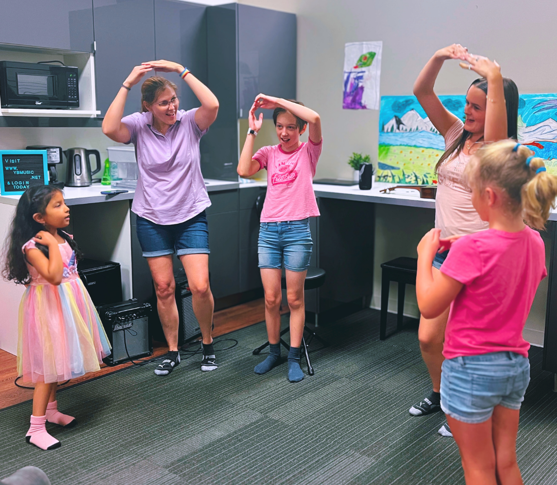 Kids of different ages join in a musical activity feeling capable and confident at summer camp.