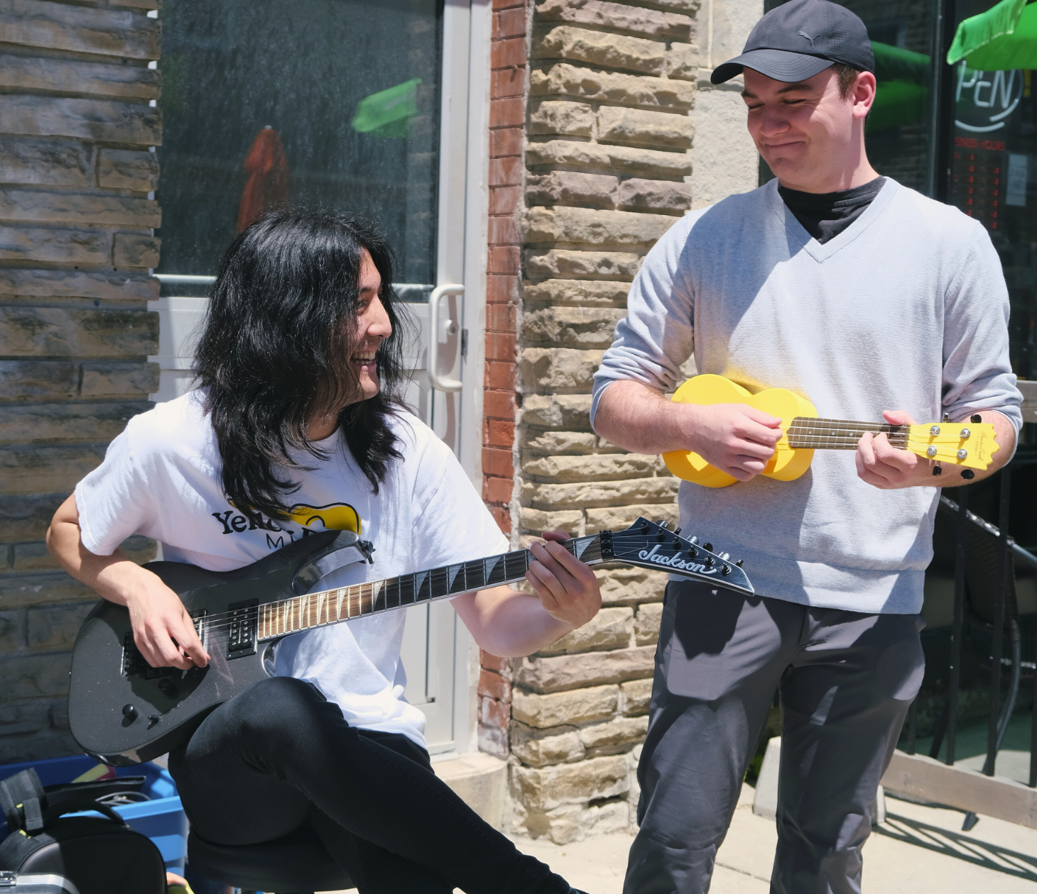 Two music teachers having fun while playing their instruments as a group.