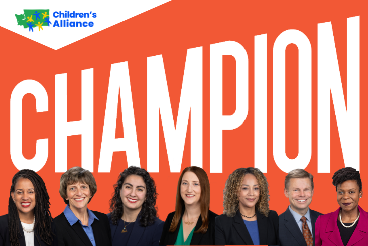 A group of award winners in front of the word "Champion"