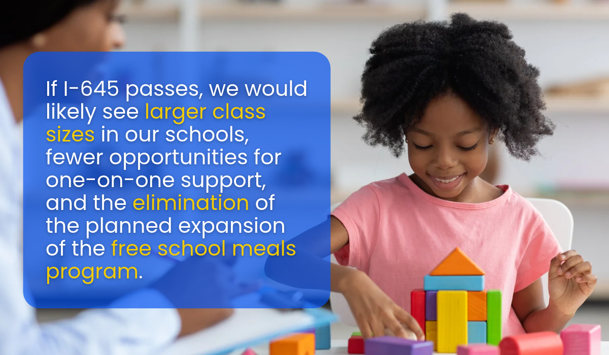 A young Black girl smiles while playing with blocks in a classroom setting