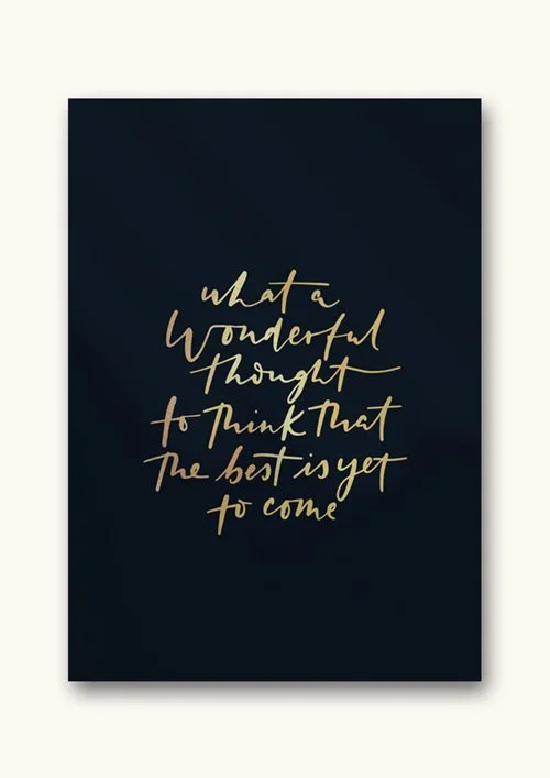 Dark blue background with handwritten-style gold text that reads, 'what a wonderful thought to think that the best is yet to come.'