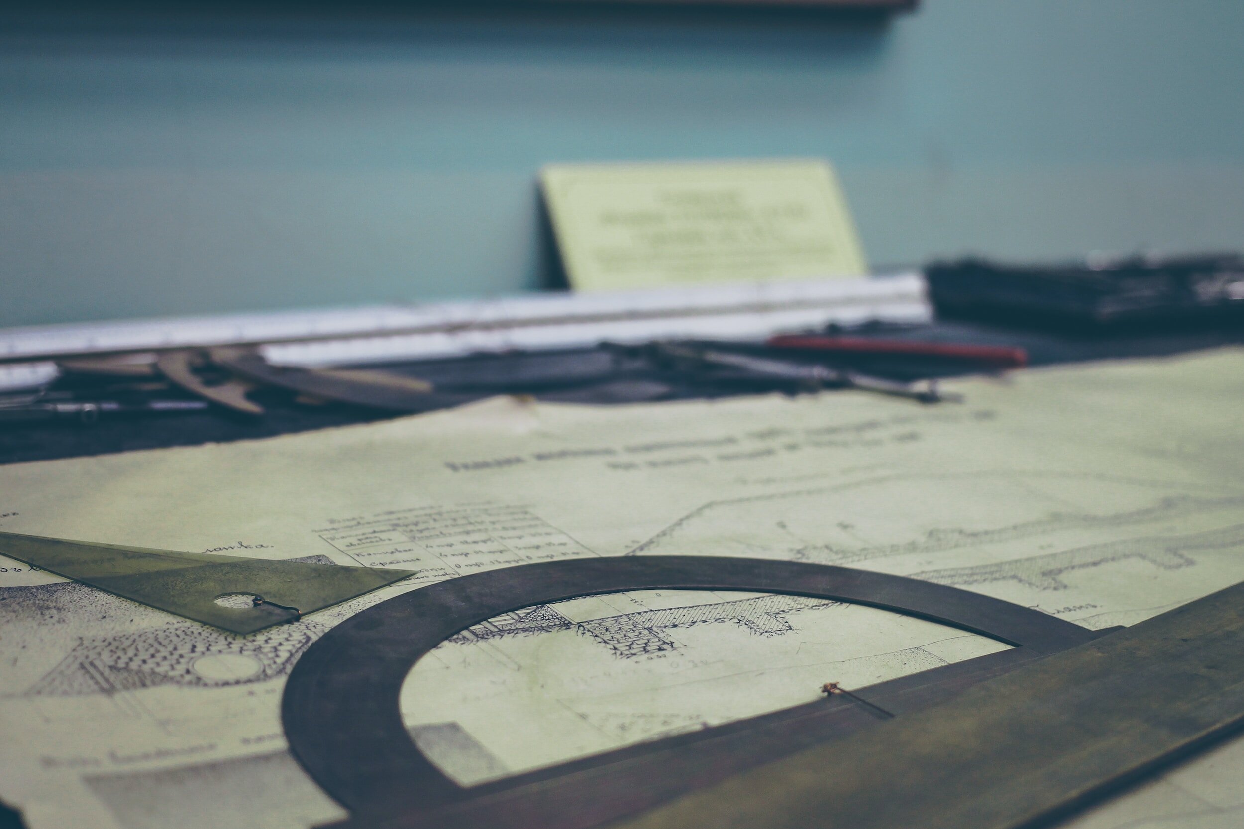 Architectural drafting tools and a blueprint on a desk