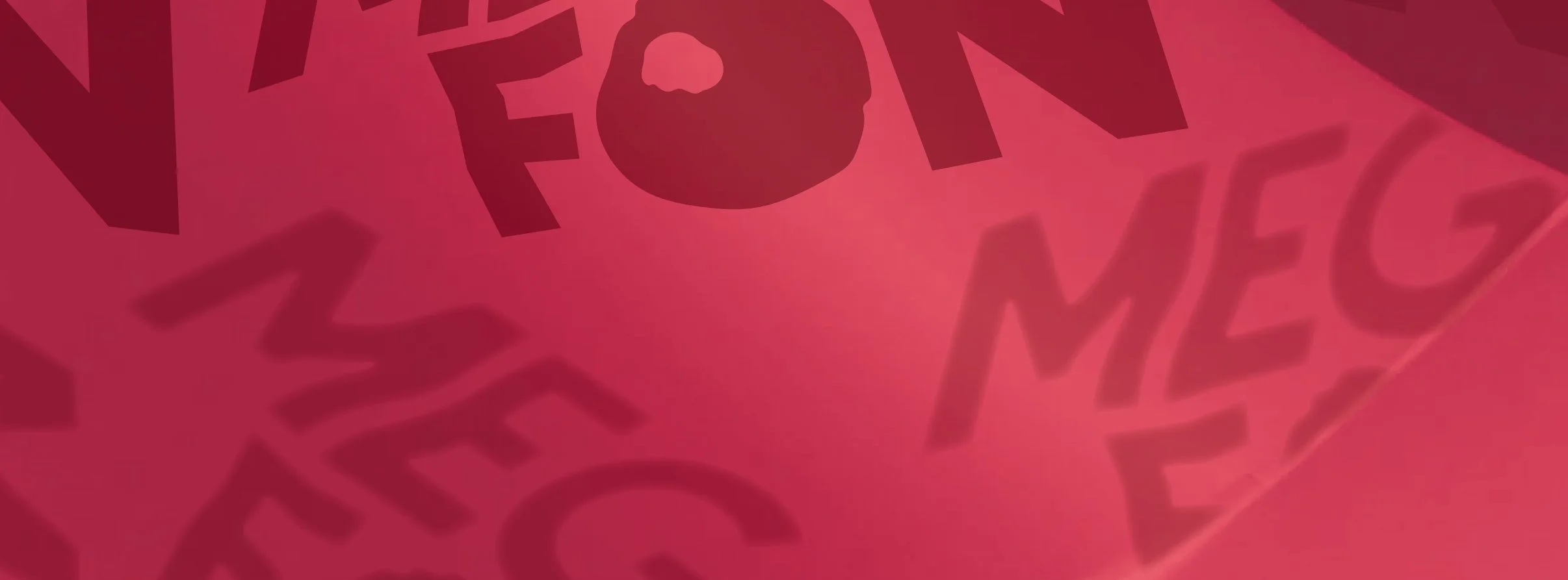 Close-up of red paper with words and images printed on it, including a person's face silhouette and the word 'MEGAFON' in stylized font. Brand design made by TBD Studios.