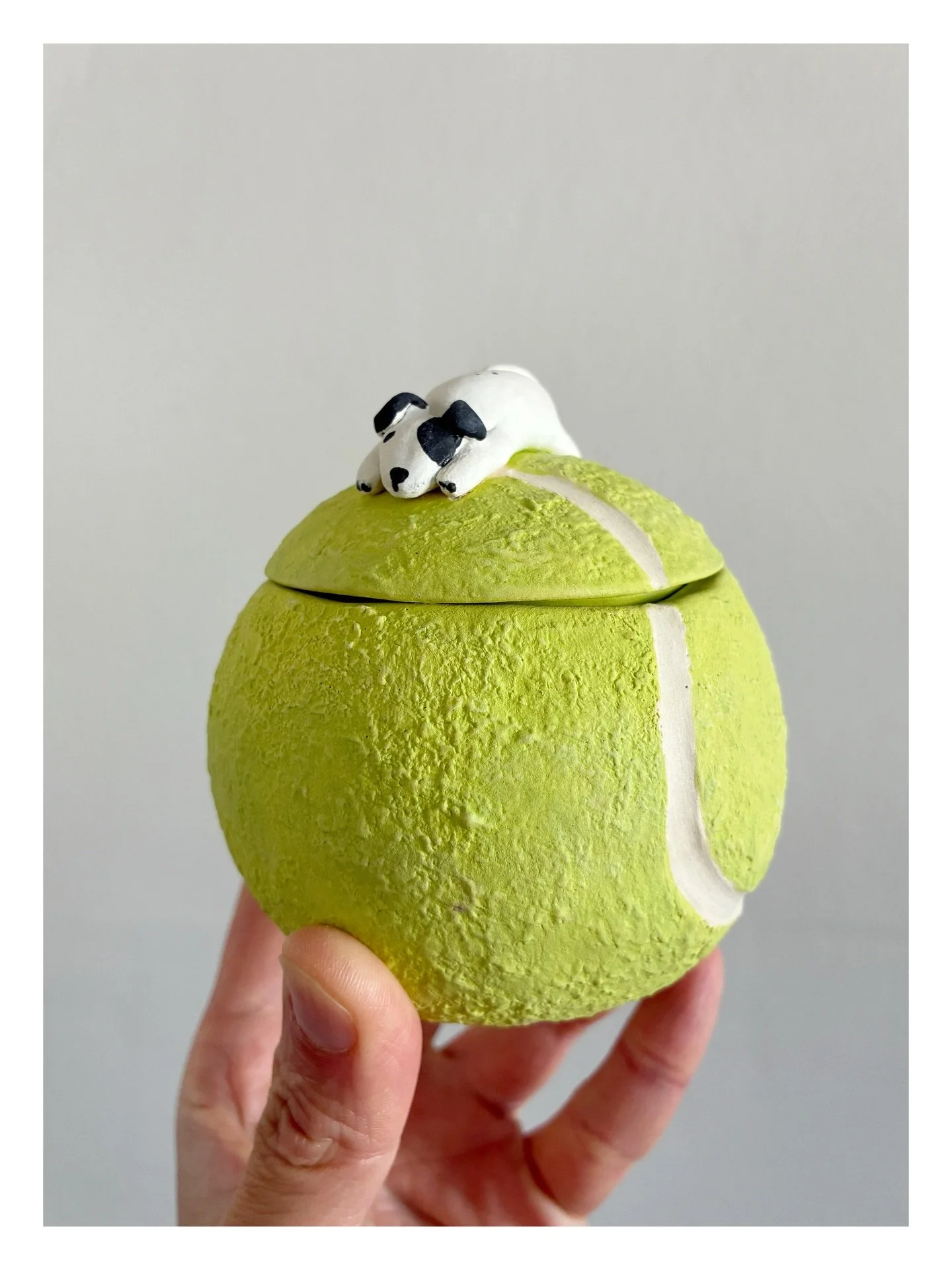 Tennis Ball Jar. This is a pinch-pot jar I made by joining two small bowls and turning it into a ball. I then sliced the top off to make a lid and added a teeny version of my ball obsessed dog. He&rsquo;s taken home about 120 balls this year alone! I