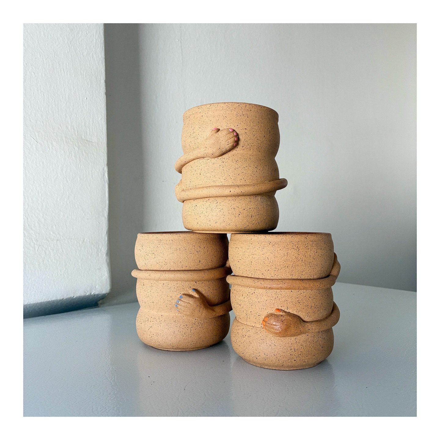 Hug Mugs, now with pink, blue, and orange nails 💅 
.
.
.
.
#ceramics #pottery #mugs #hug #nails