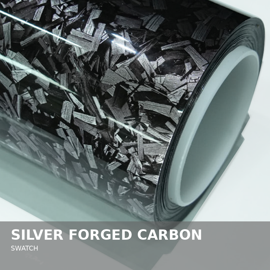 Close-up of a roll of silver forged carbon material with a black and gray marbled pattern.