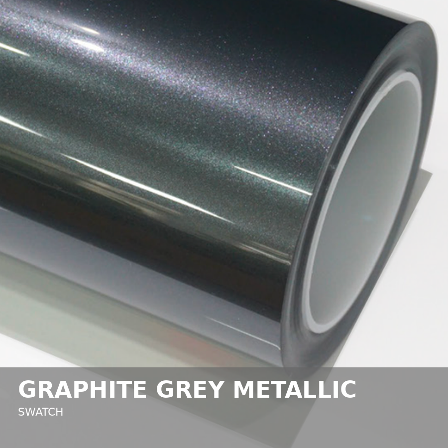 Close-up of a swatch of graphite grey metallic material, showing a shiny, reflective surface with a glittery finish.