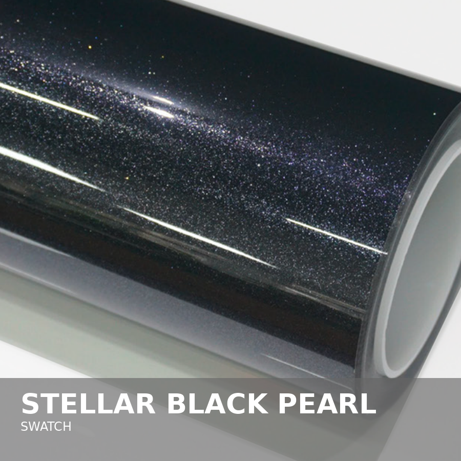 Close-up of a roll of vinyl wrap with a starry black pearl design, used for vehicle or surface wrapping.