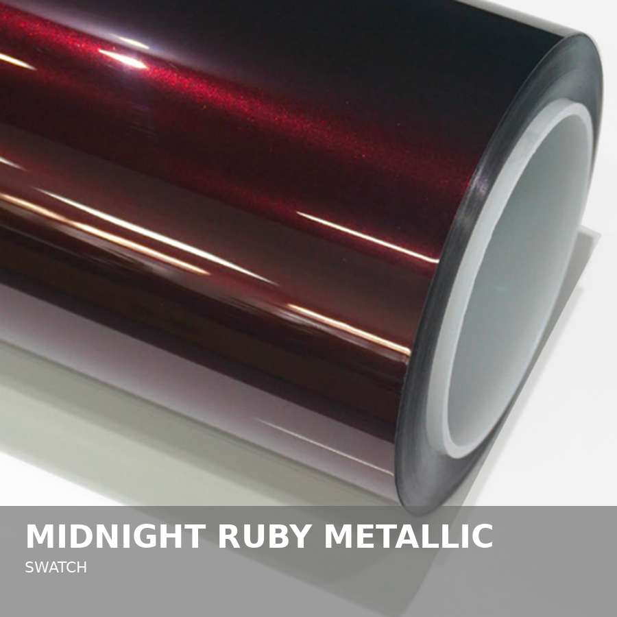 Close-up of a metallic vinyl wrap roll labeled 'Midnight Ruby Metallic' with a dark red, shiny, reflective surface.