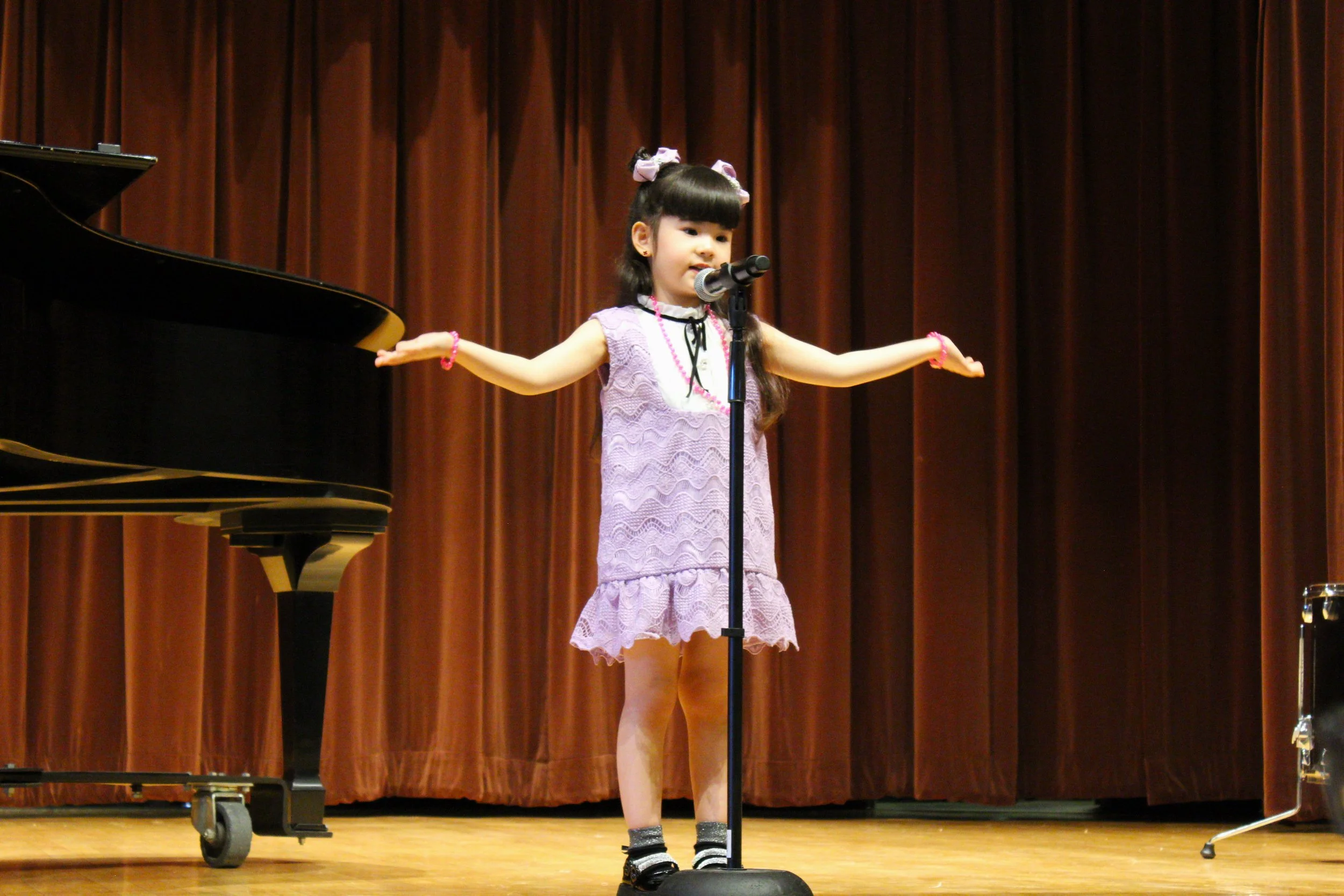 Ariana Singing Arms Outstretched.jpg