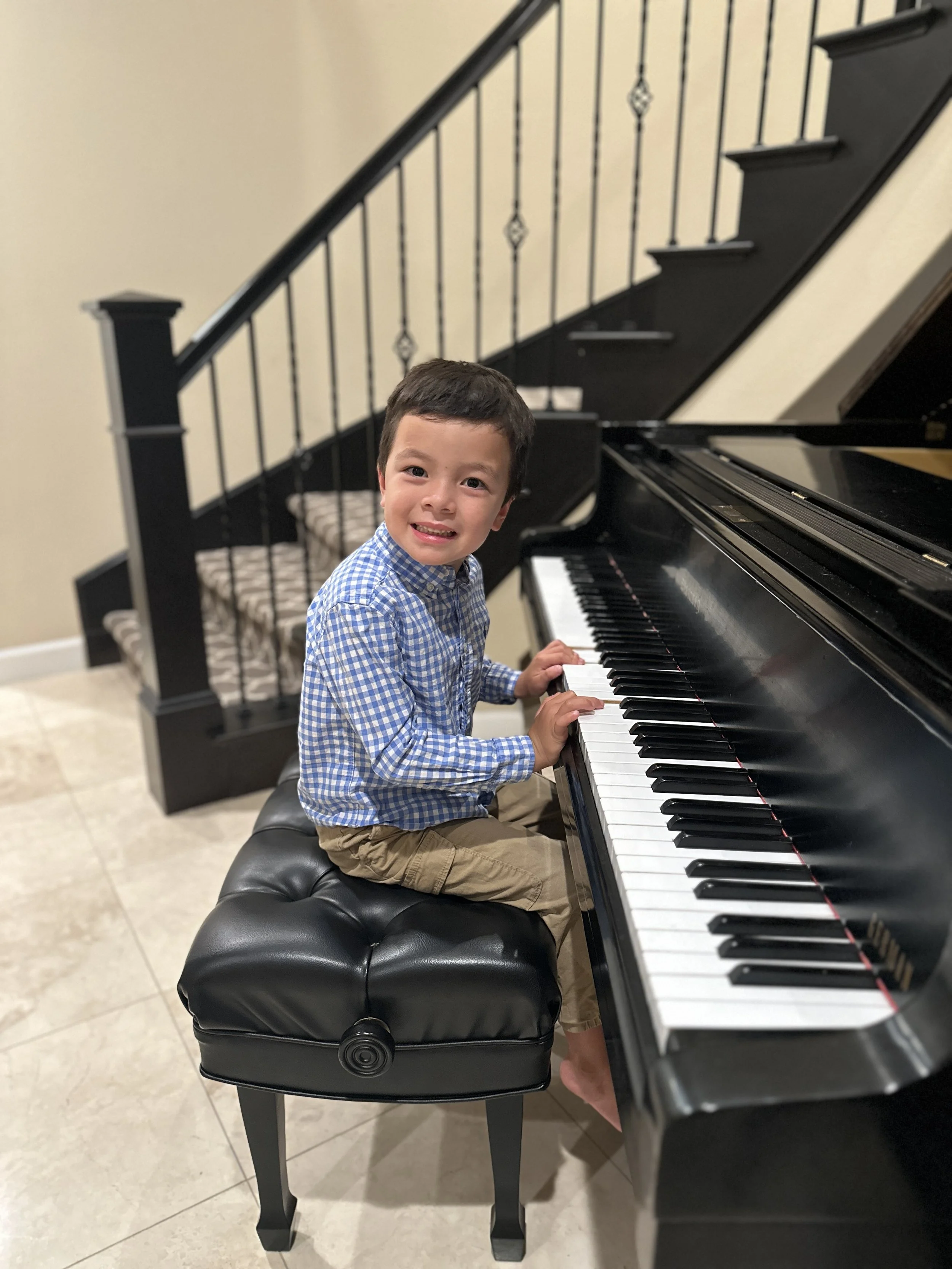 Bennett piano student at piano during music lessons.jpg